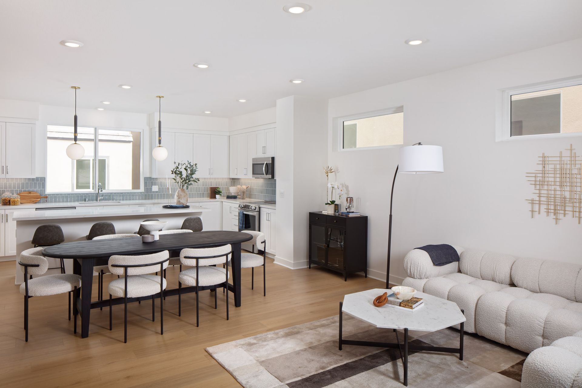 Model home great room featuring an open layout for kitchen, dining, and living.