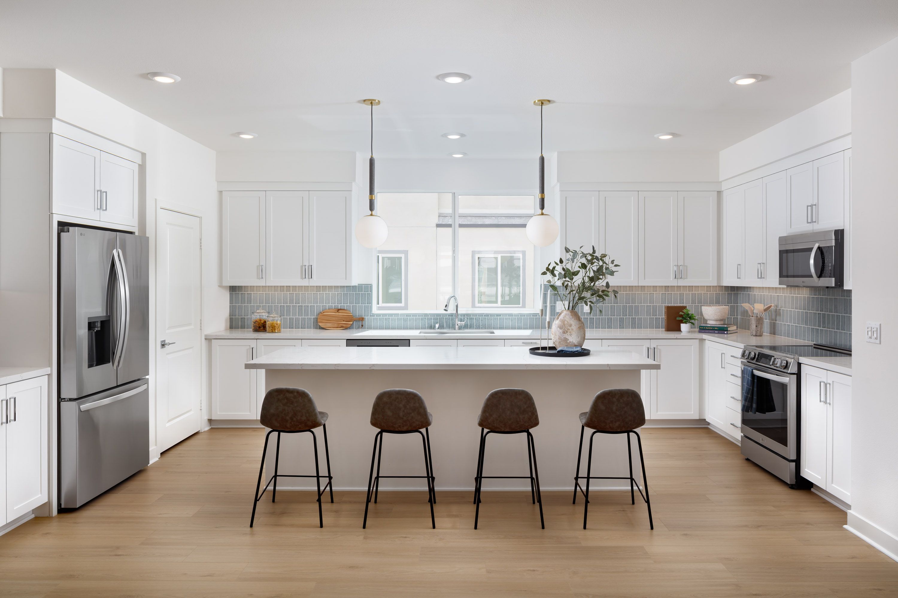 Model home kitchen island with generous serving space and seating