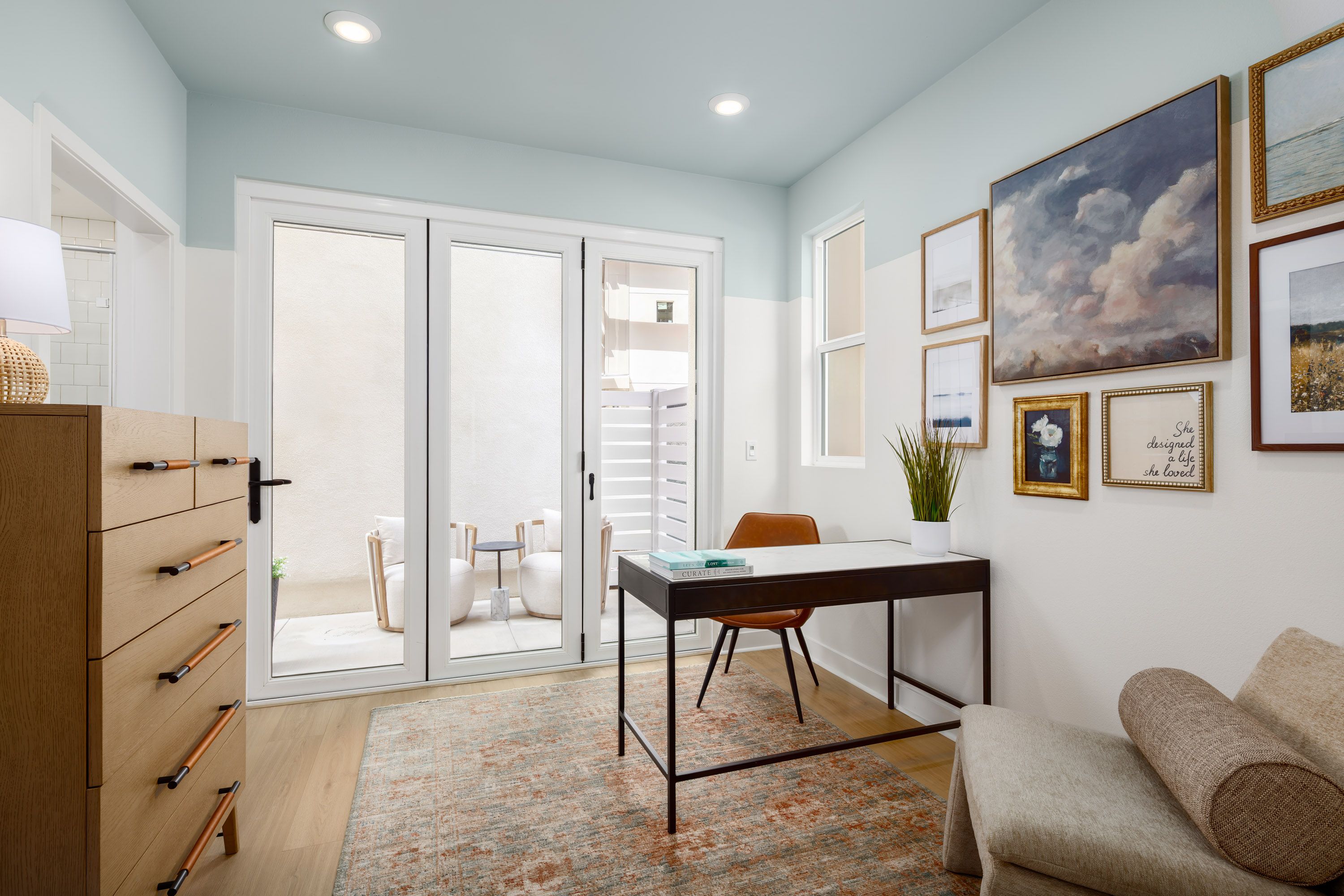 Model home bright den with sliding doors that open to a private outdoor patio