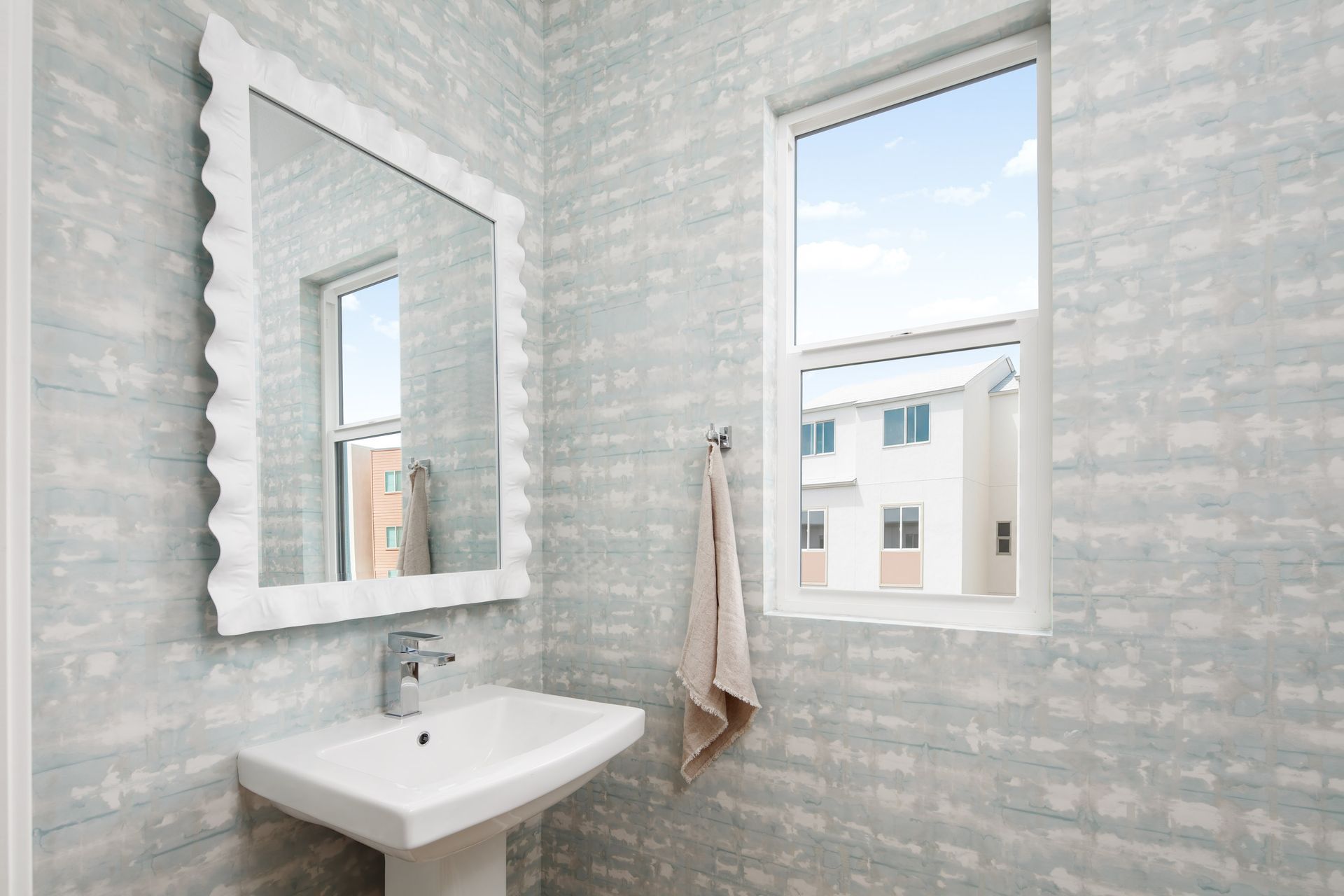 Model home fresh, light-filled powder bath that adds a refined touch to the main level.