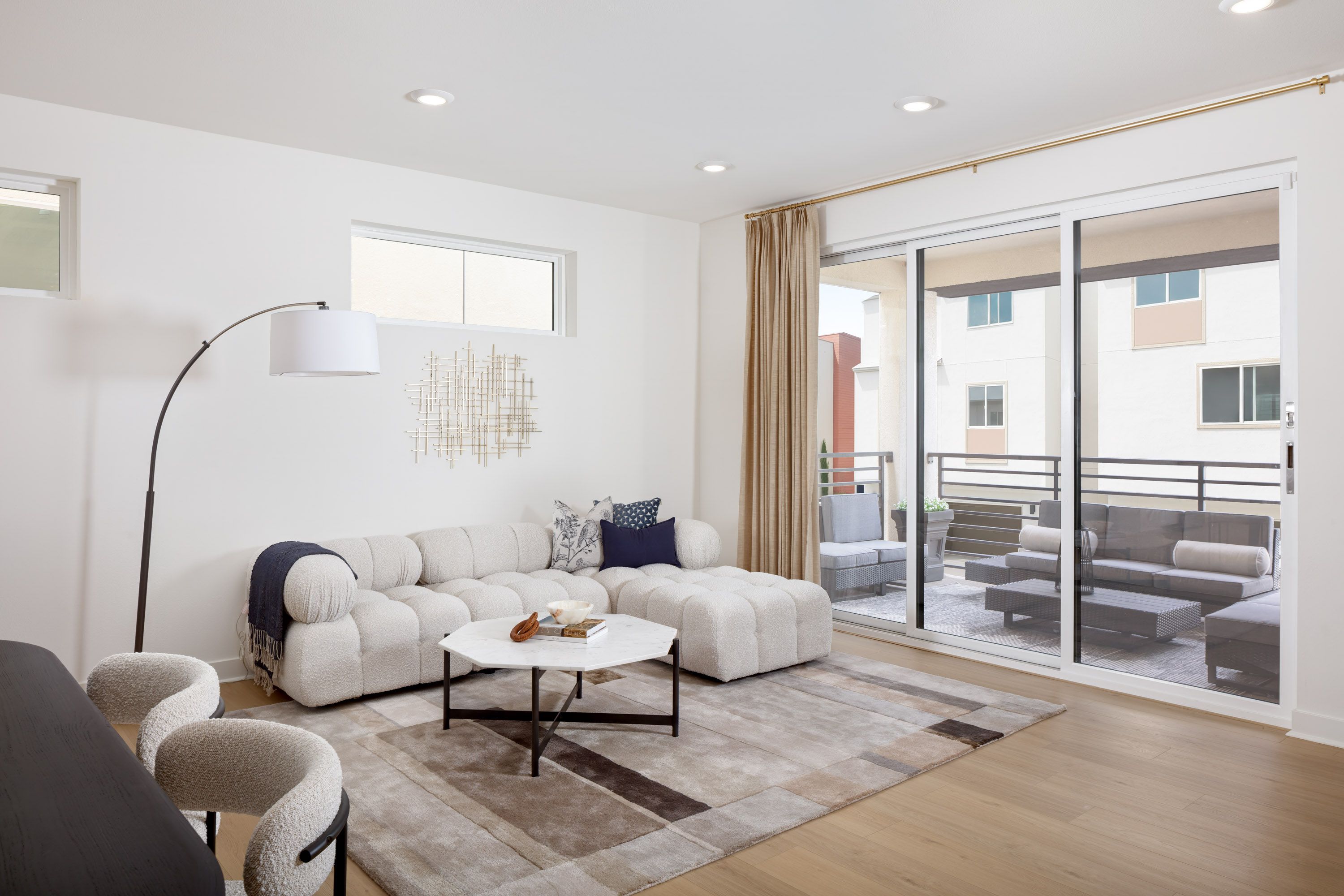 Model home bright living area adjacent to outdoor deck