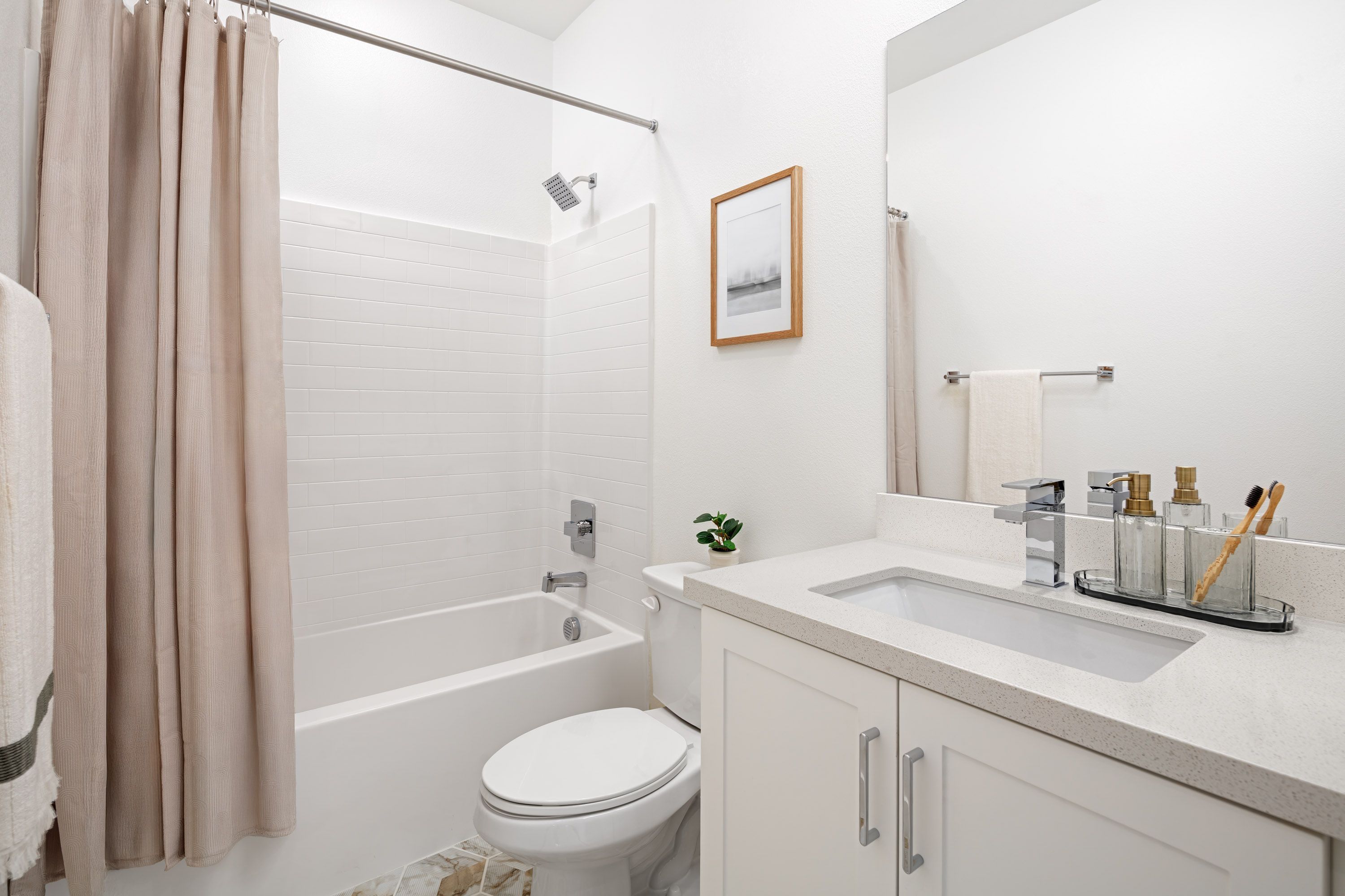Model home bright secondary bathroom featuring a single sink and shower