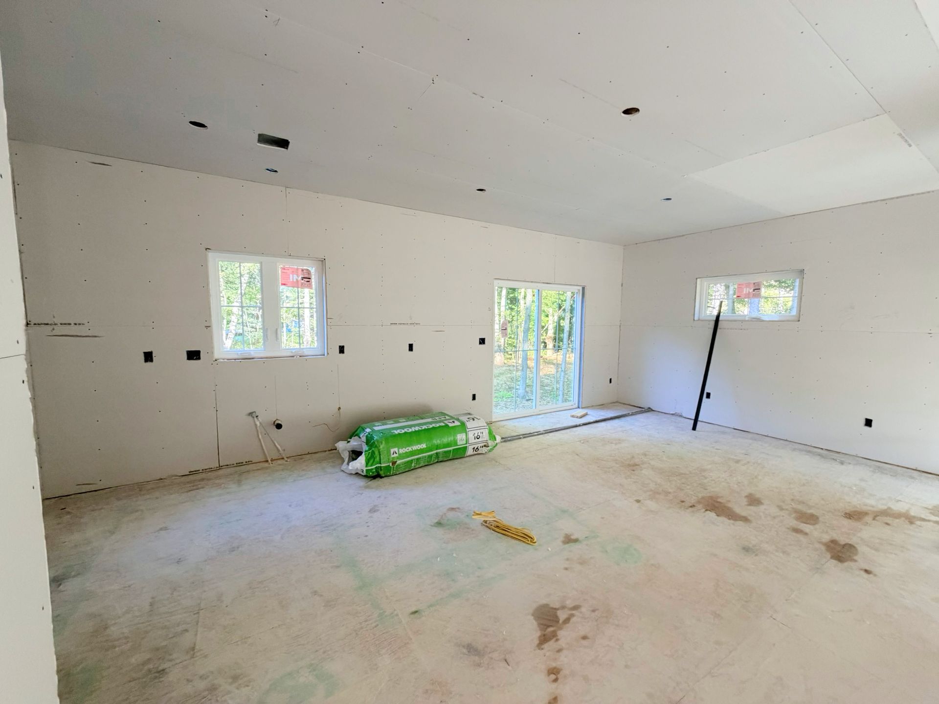 Interior progress view of the dining area featuring sliding doors that lead to a 10' x 12' pressure treated deck.