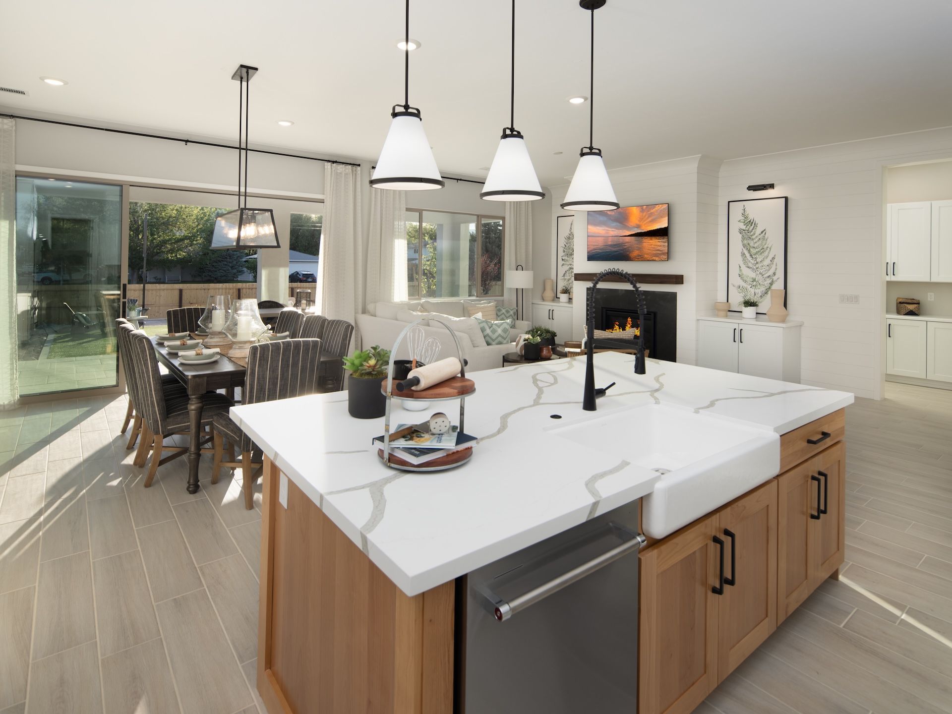 Plan 1's Kitchen, Dining Area & Great Room Featuring A Western Multi Slider To The Extended Covered