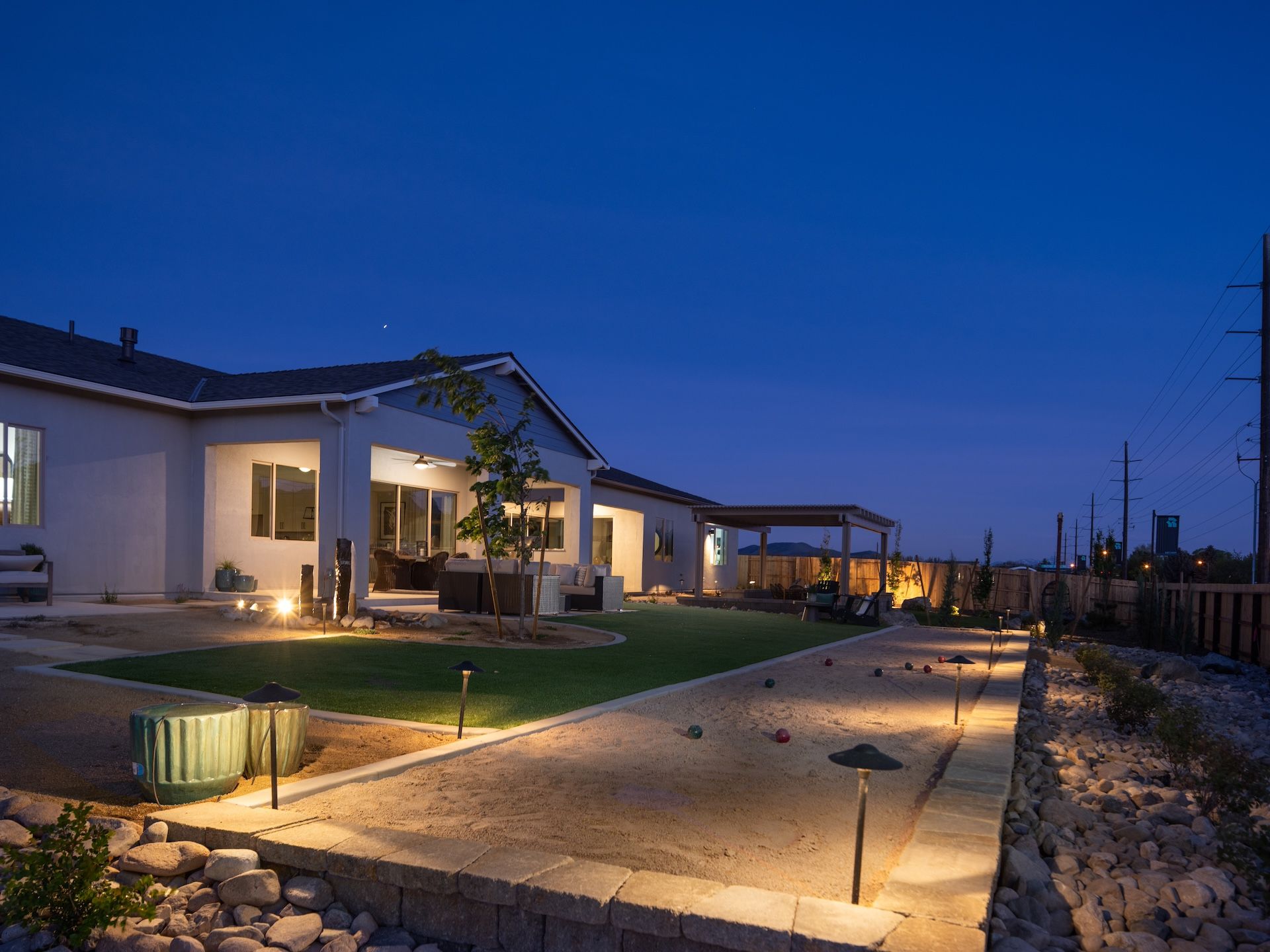 Backyard Of Our Plan 1 Model At Night Showing The Extended Covered Loggia