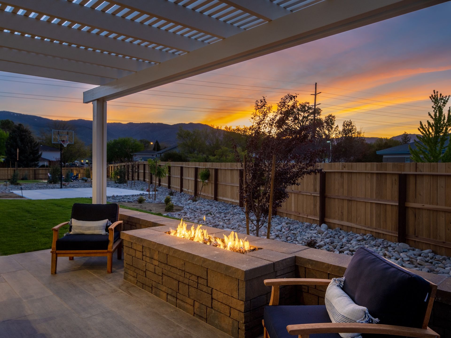 Our Plan 4X Model Home's Backyard With A Covered Patio & Built-In Fire Pit