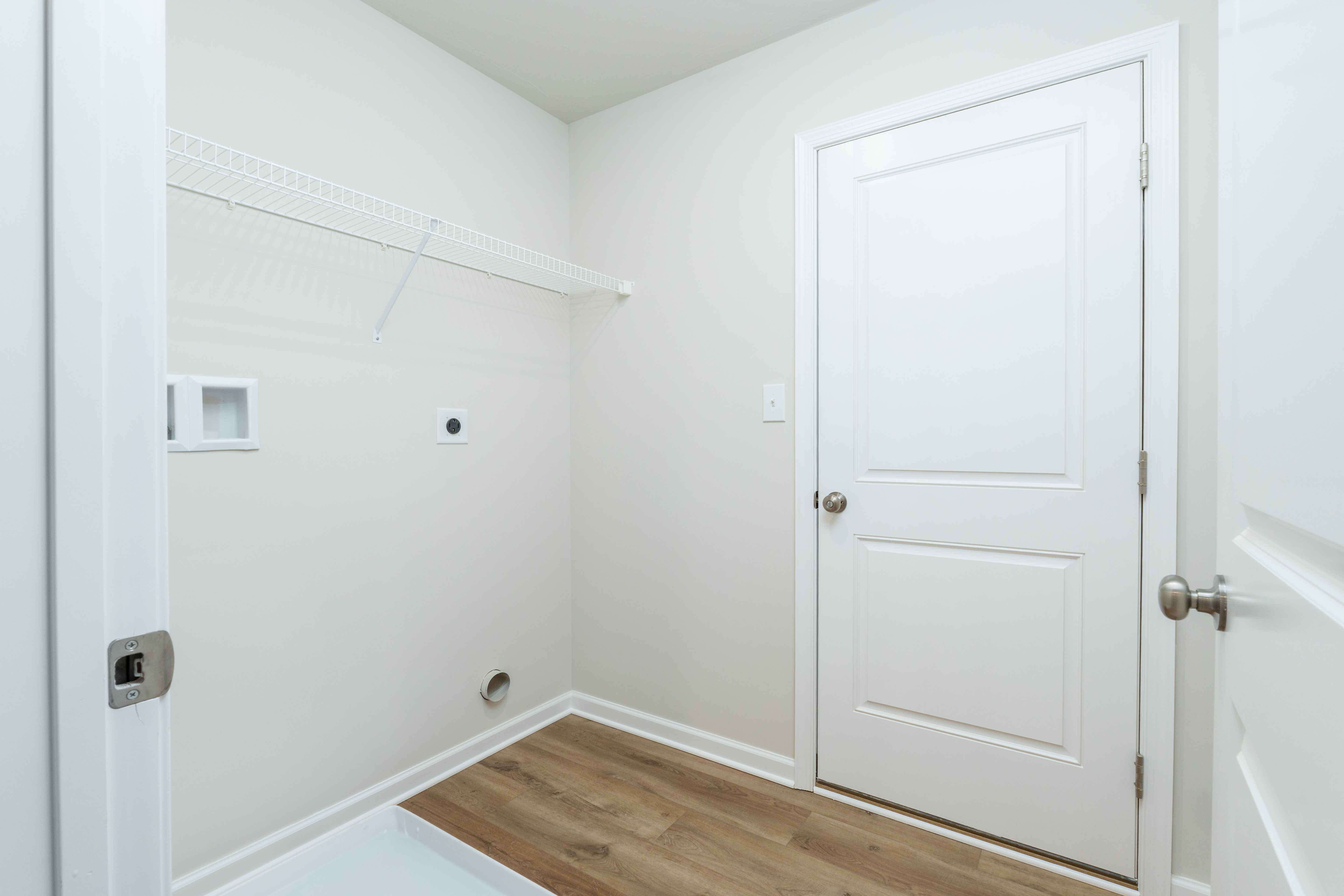 Laundry room with shelving, washer and dryer hookups, and luxury vinyl plank flooring