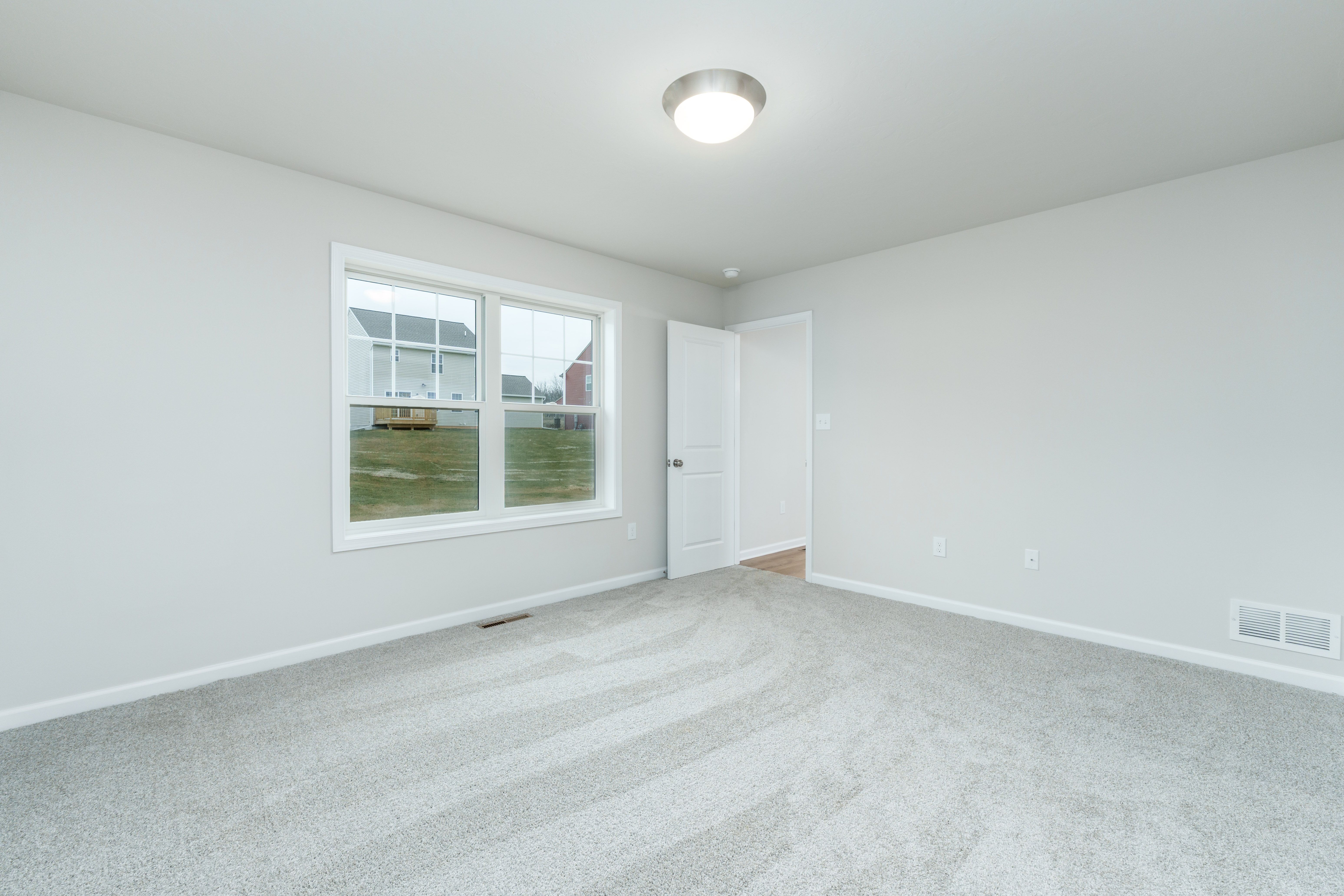 Owners bedroom featuring carpeted floor, flush-mount ceiling light, and open layout