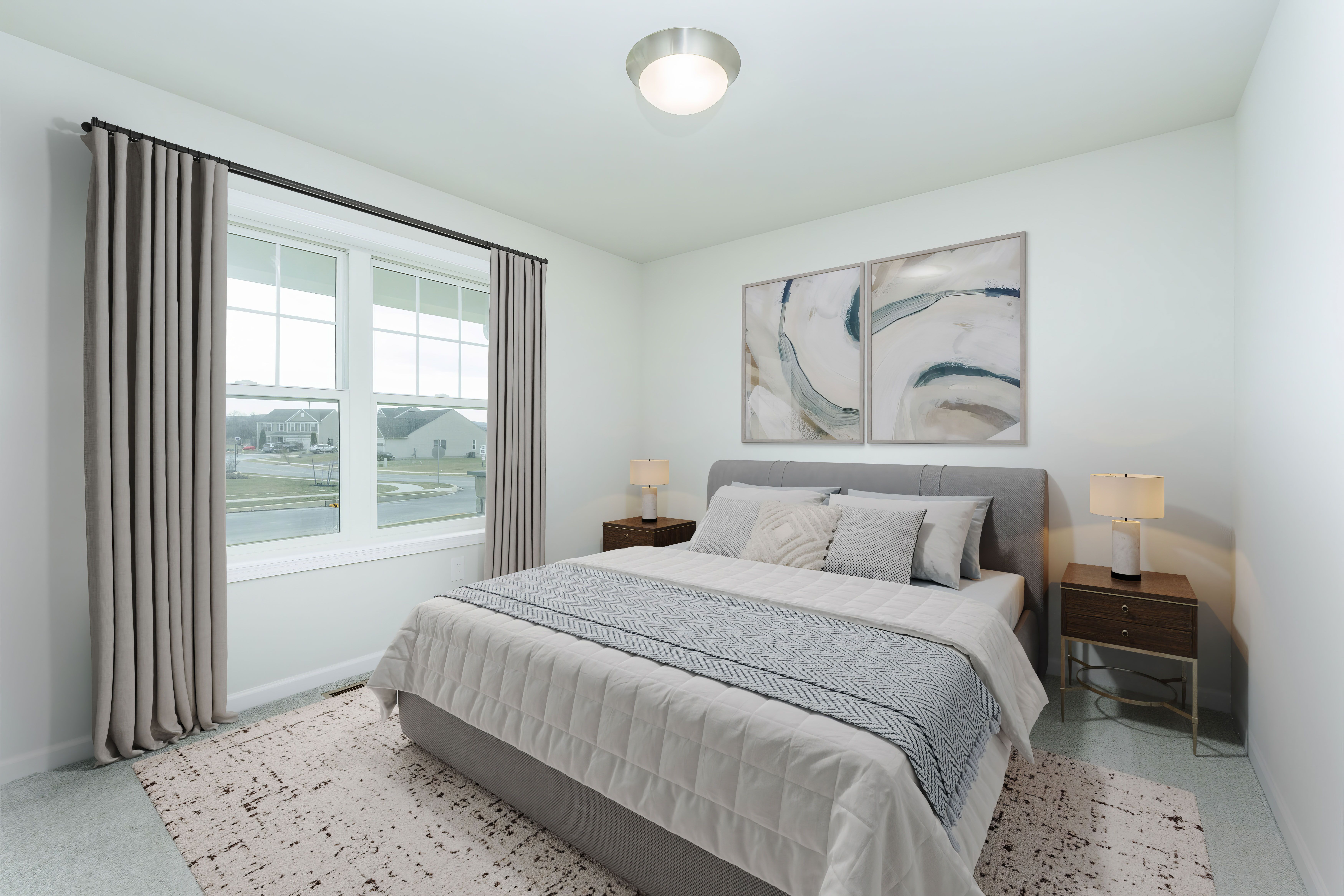 Alternate view of bedroom with bed, wall art, closet doors, and window bringing in natural light.