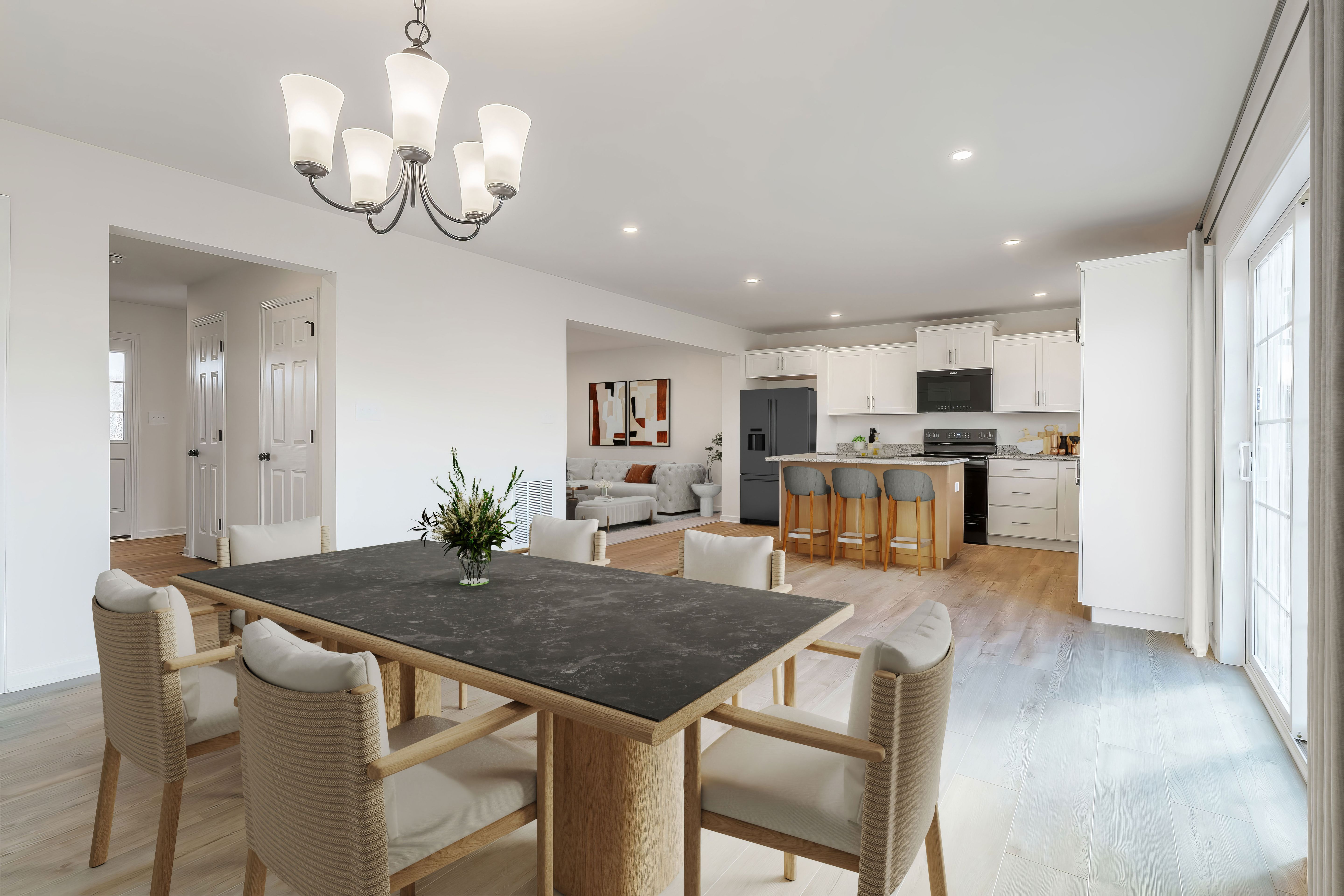 Open breakfast area and kitchen with island seating, white cabinets, and luxury vinyl plank flooring