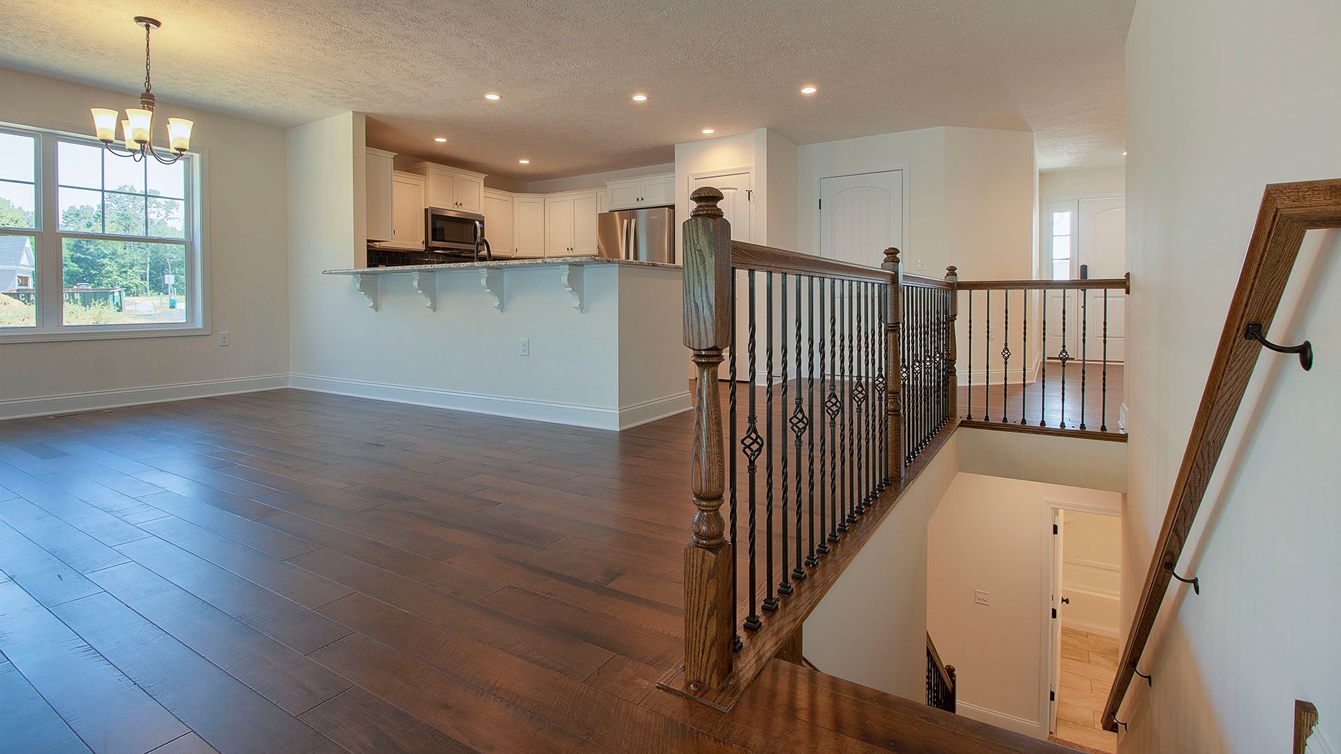 Dining area with hardwood flooring and stairs to lower level, Aspen floorplan