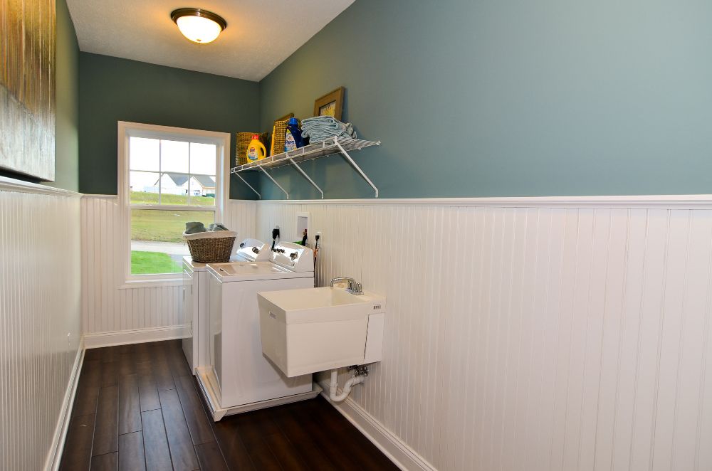 Extended laundry room with wainscoting and window