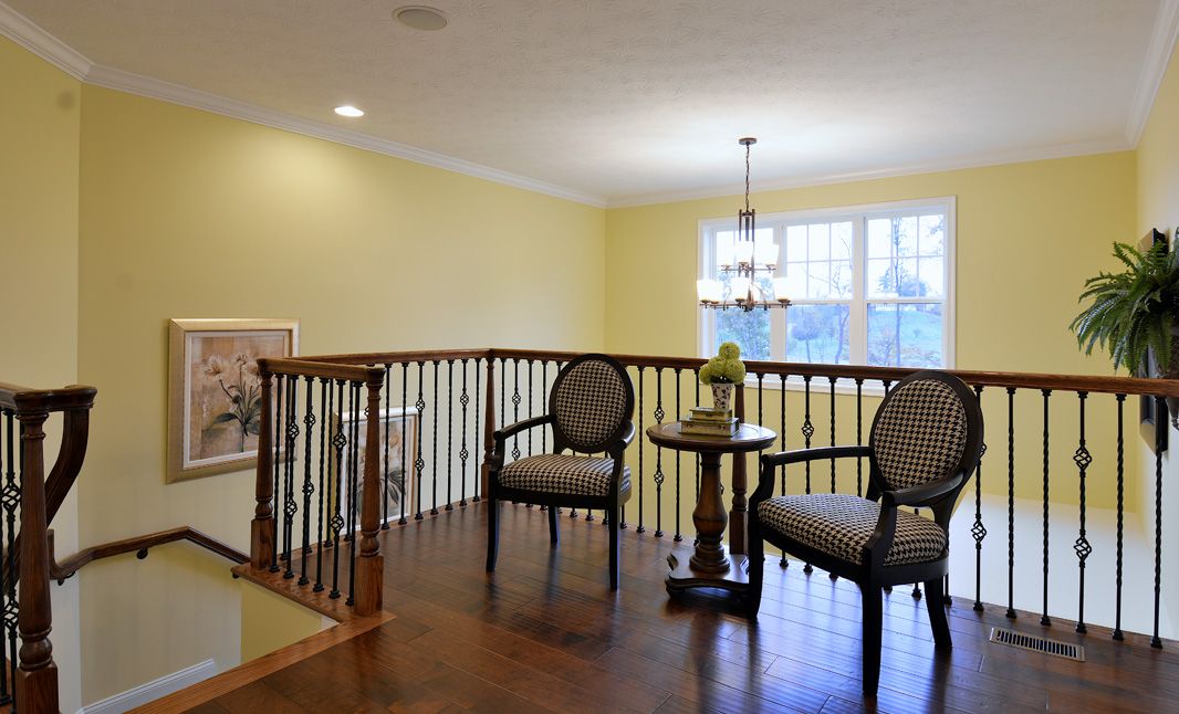 Loft area with hardwood flooring overlooking two story foyer
