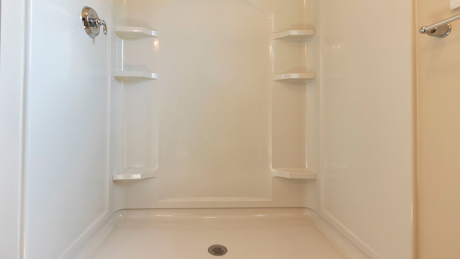 Shower stall with corner shelves