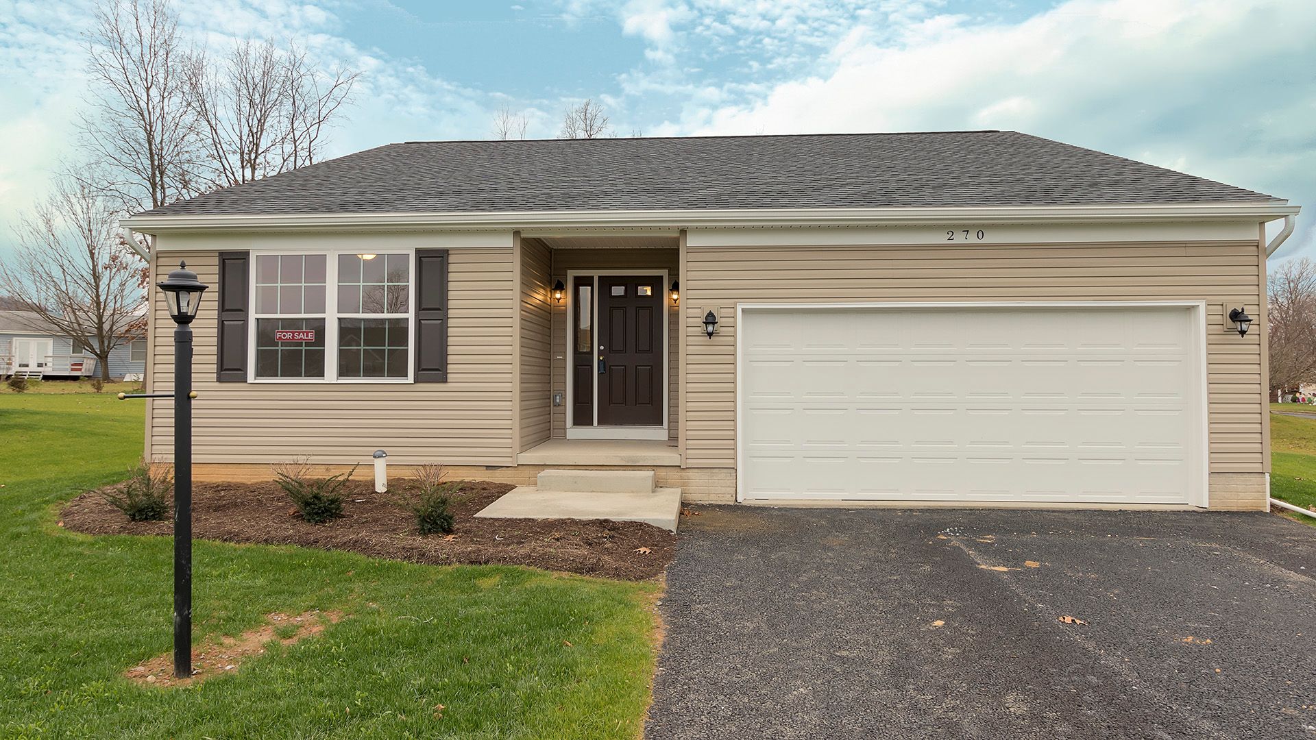 Front exterior view of the Elmcrest A floorplan by S&A Homes - vinyl siding and two car garage