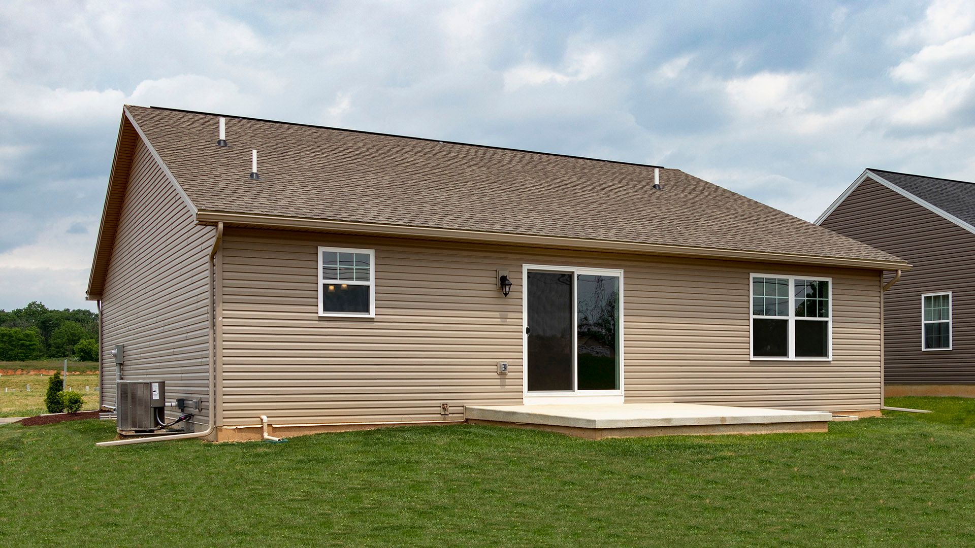 Exterior rear view of the Elmcrest A ranch floorplan by S&A Homes - sliding glass door to rear patio