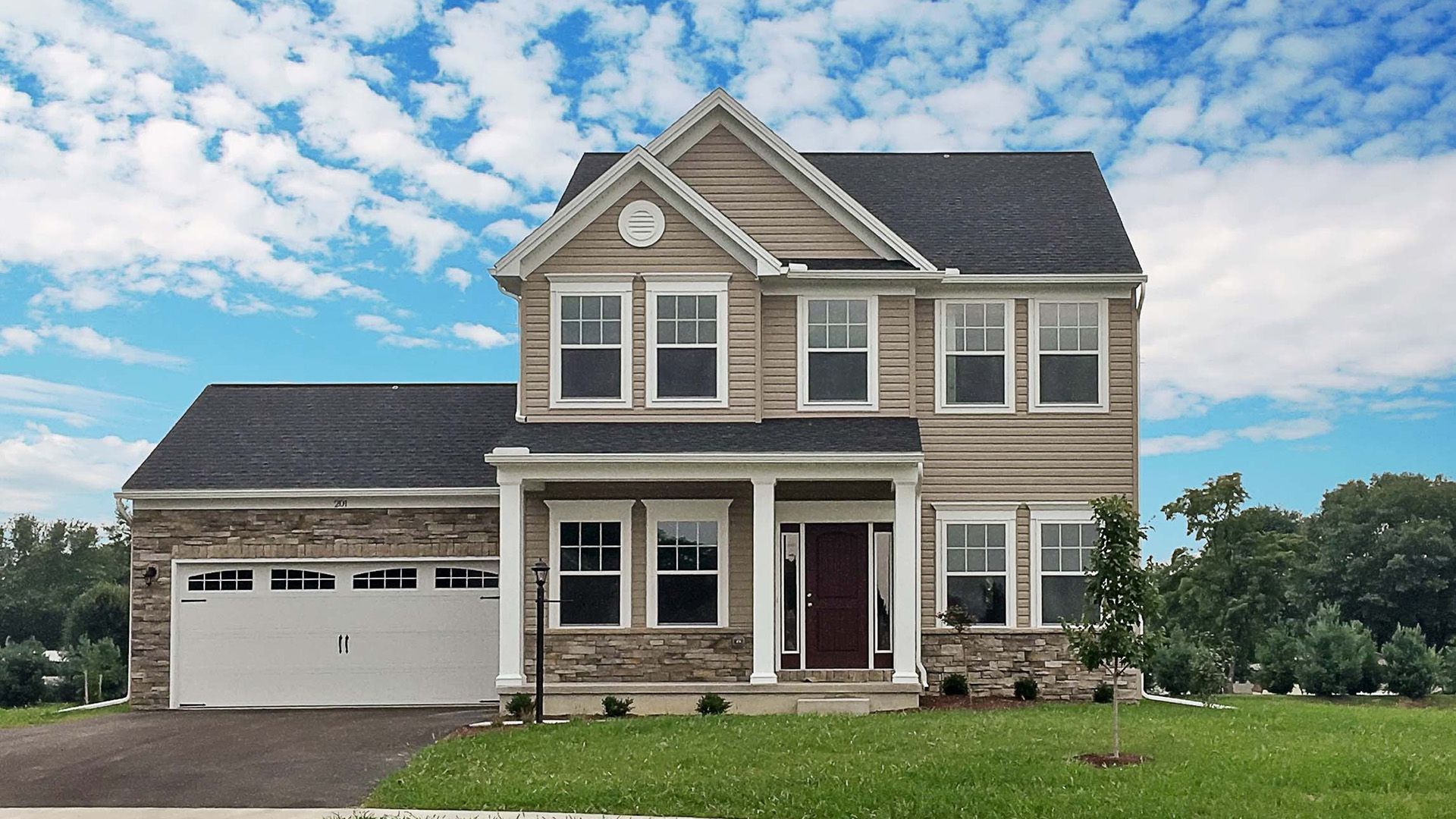 The Brandywine floorplan by S&A Homes - exterior view - 2 story home with vinyl siding and partial stone, partial front porch and 2 car attached garage