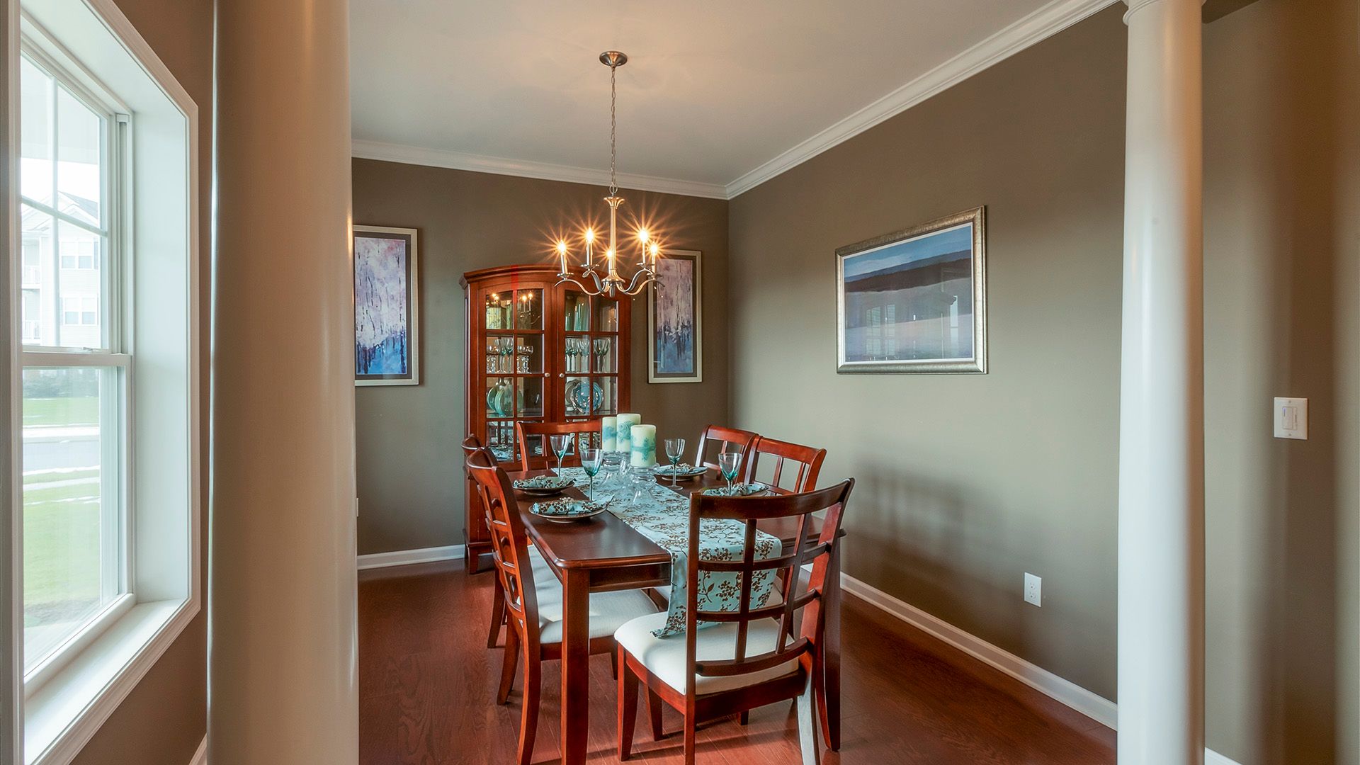 Furnished formal dining room with decorative columns in Crestmont floorplan by S&AHomes
