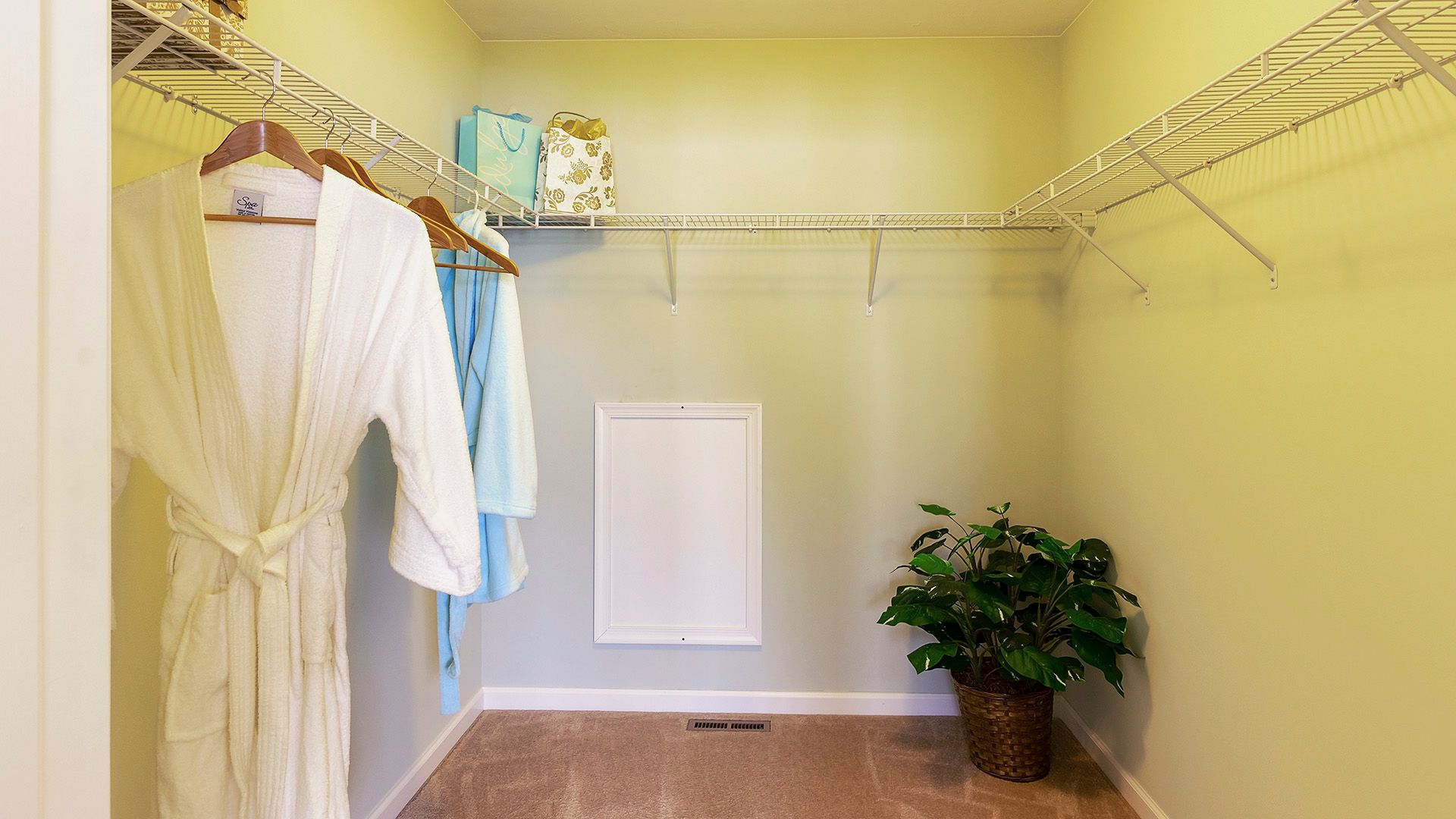 Robe hanging in large closet with wire shelving, Crestmont floorplan