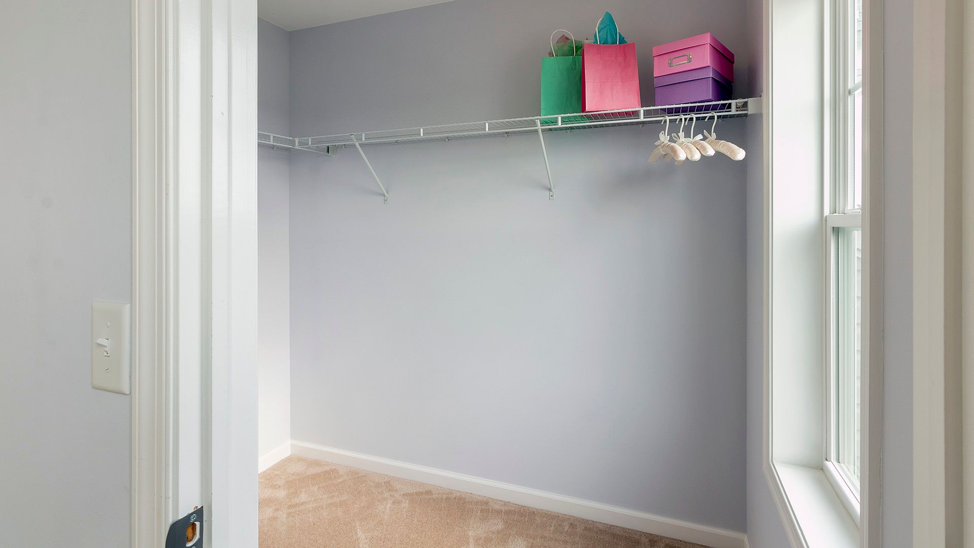Large closet with window and wire shelving in bedroom two, Crestmont floorplan