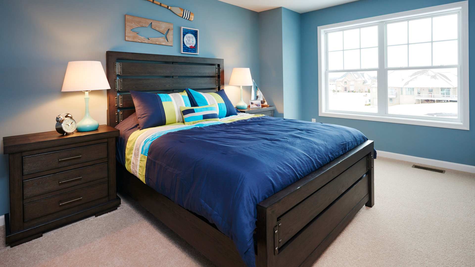 Furnished kids room with double windows on front wall and carpeted floor