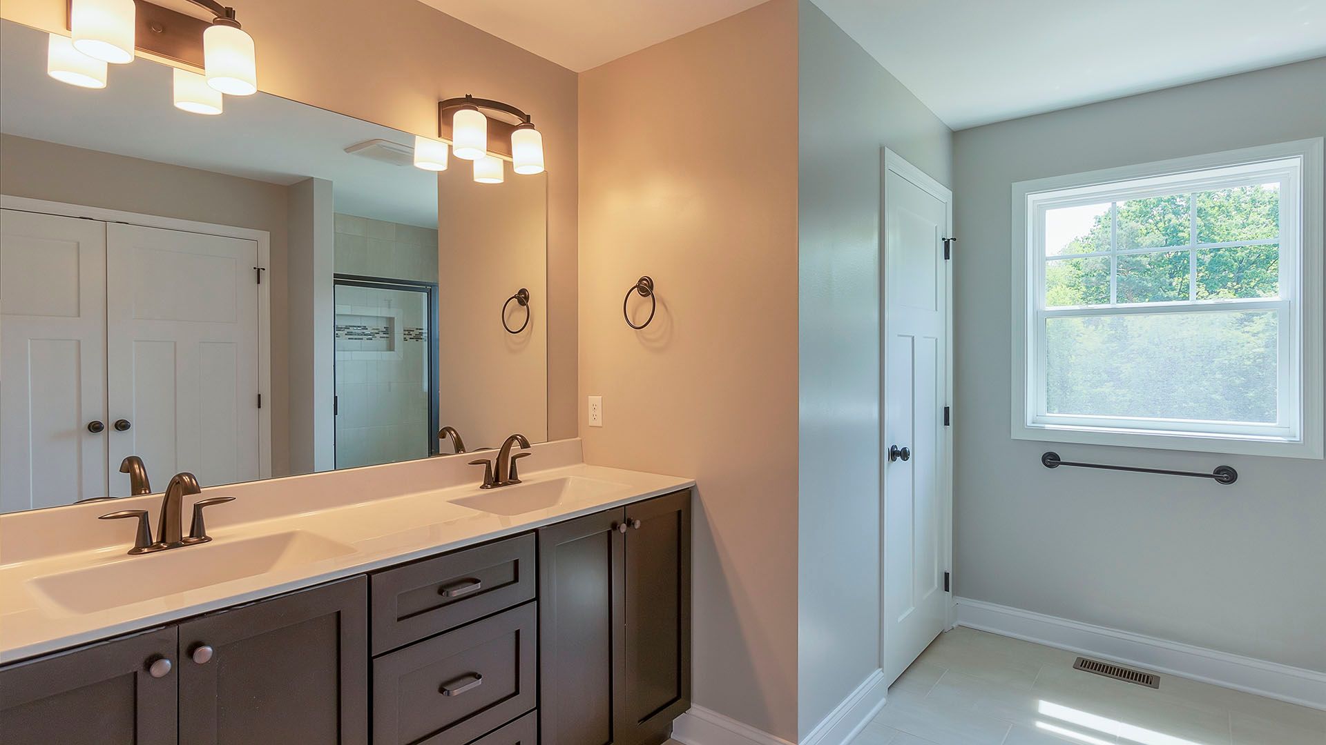 Owner's bathroom with double sink, walk in shower