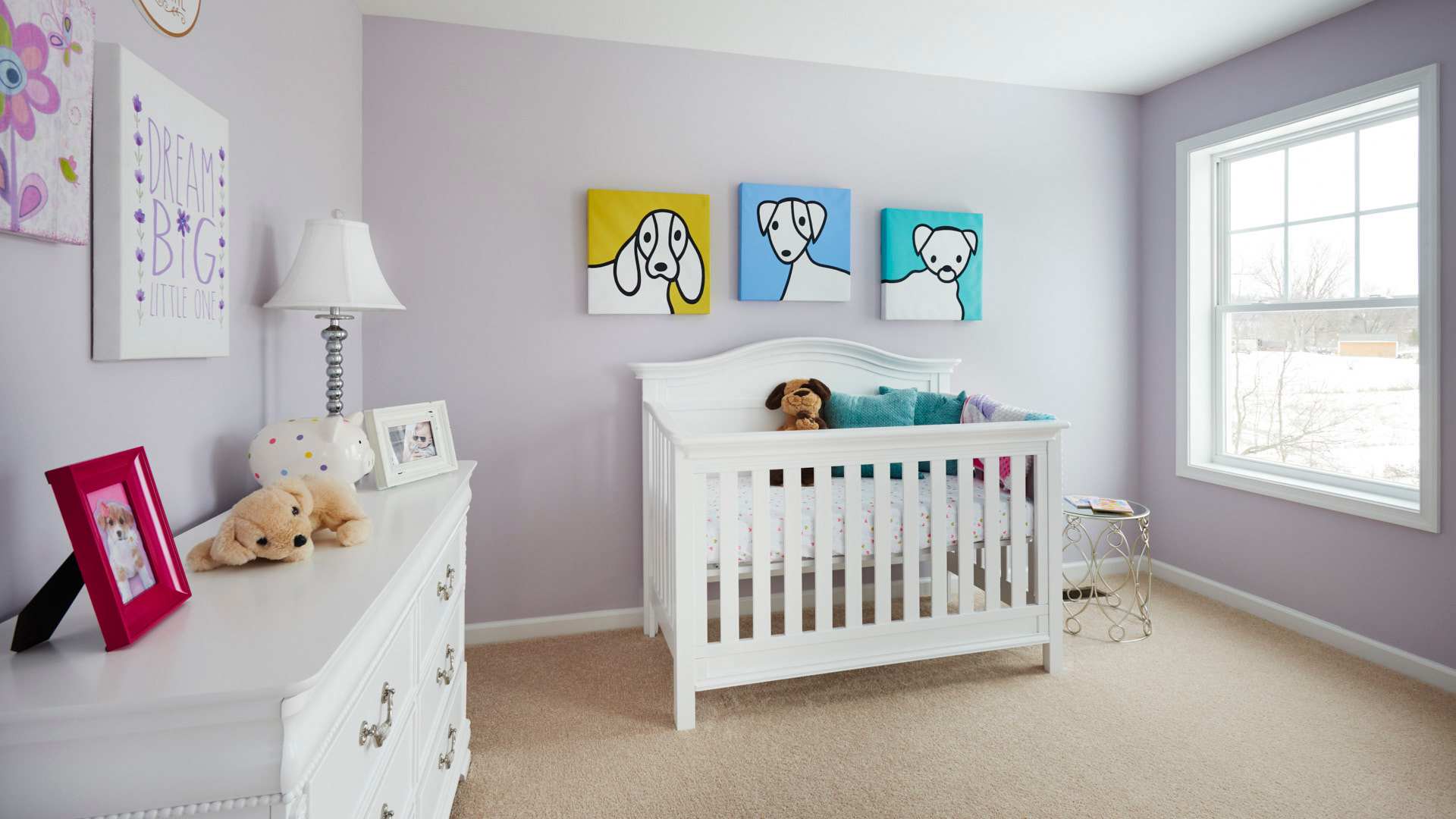 Furnished kids room with large window and carpeted floor