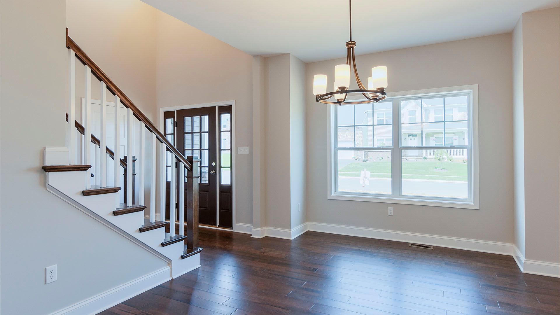 Dining area with Luxury Vinyl Tile, two windows, hanging light