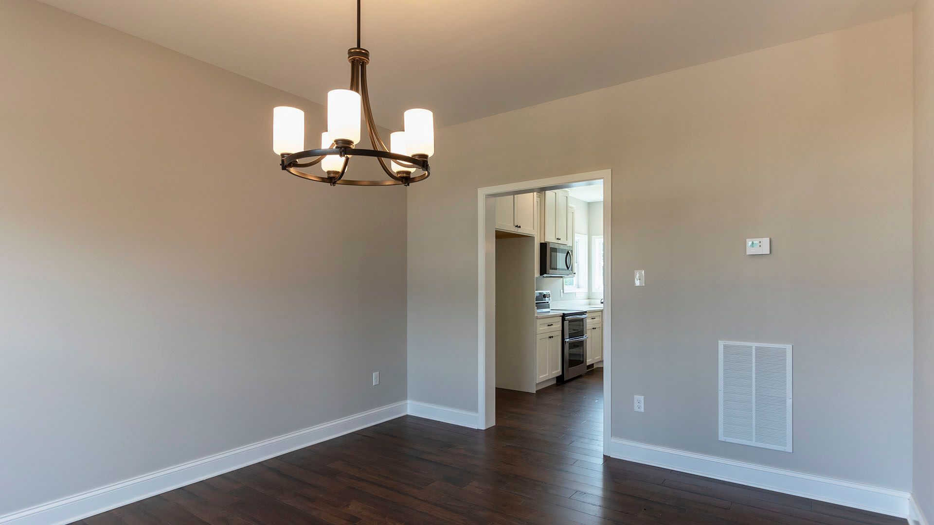 Dining room with hanging light, hardwood