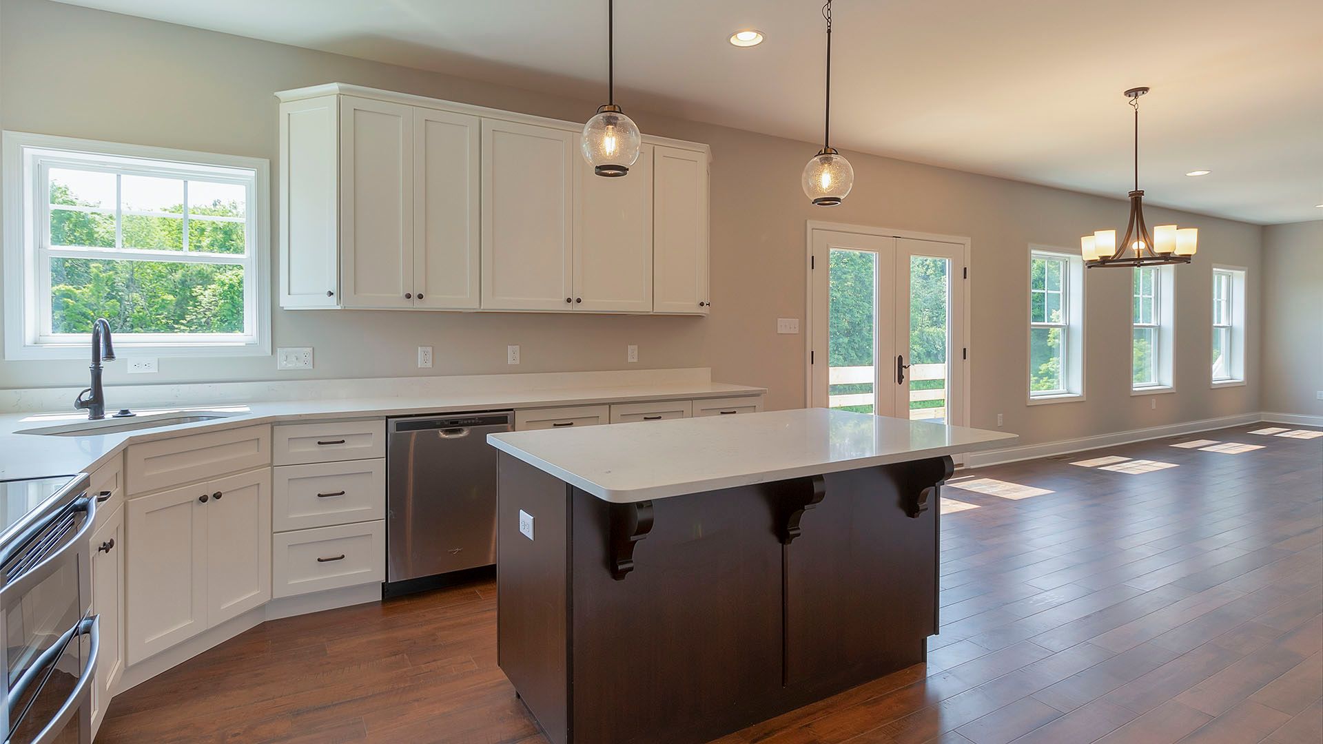 Kitchen with white cabinets, whitequartz, large island with dark cabinets
