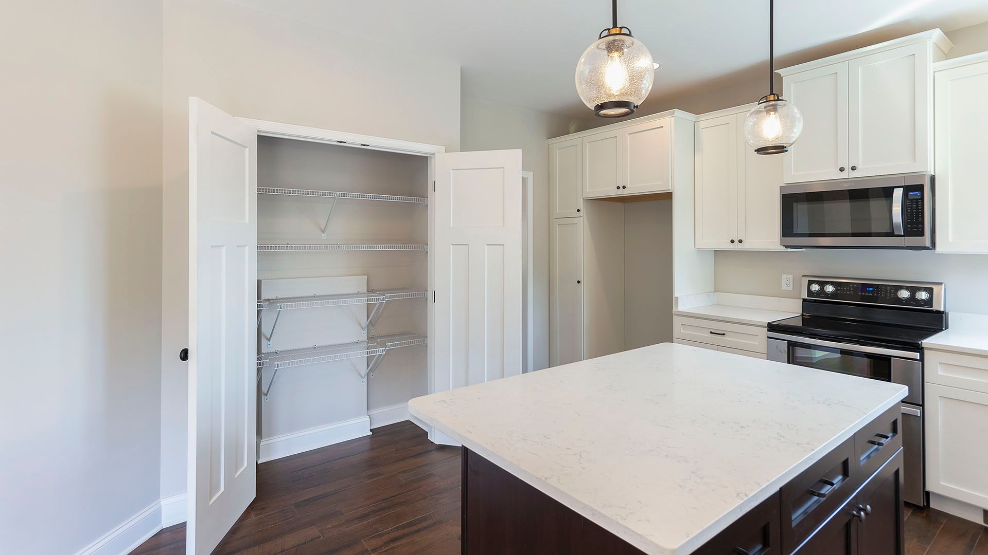 Kitchen with large island - facing pantry with double doors and wire shelving