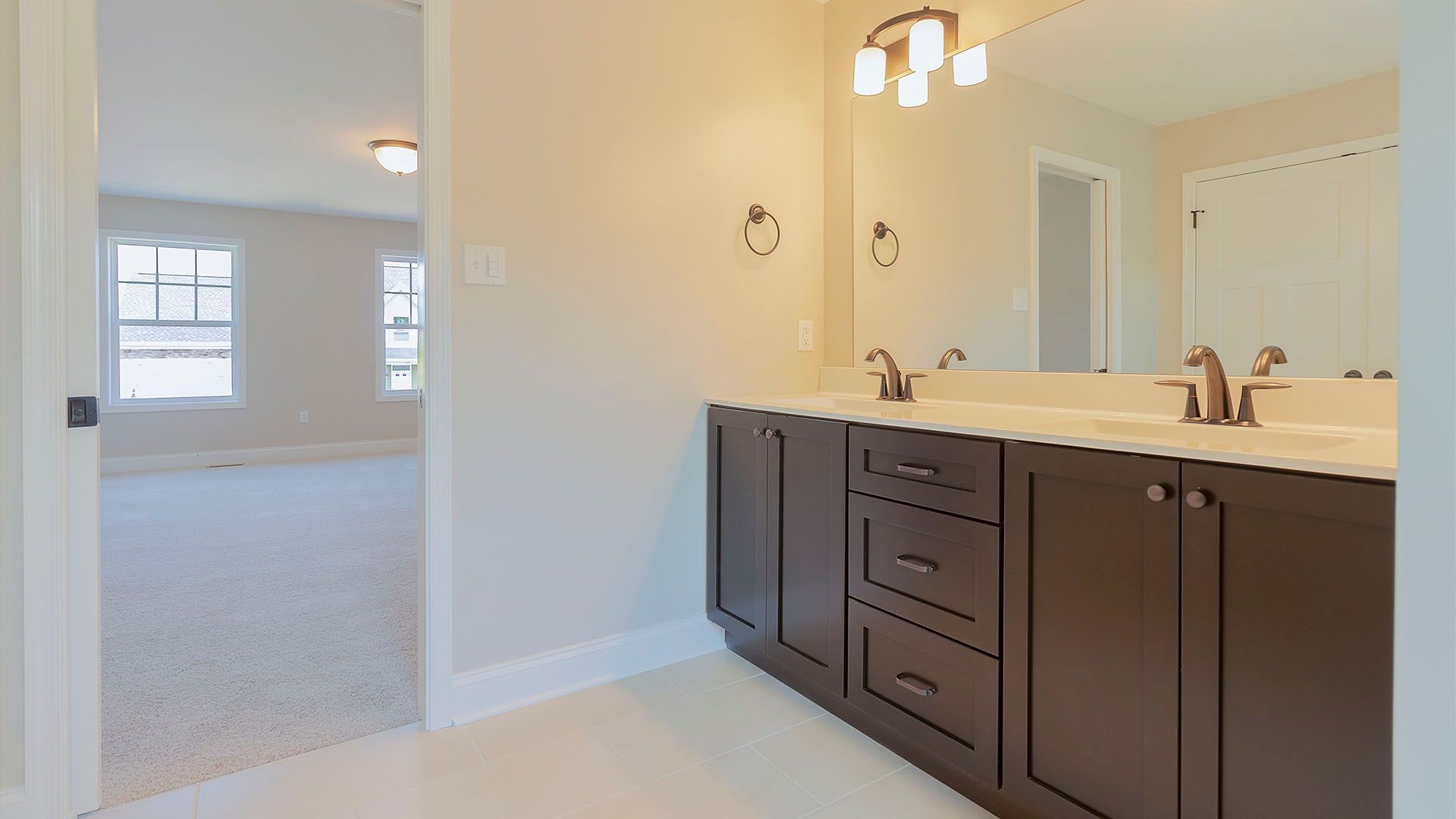Owner's Bathroom with double bowl sink, dark cabinets
