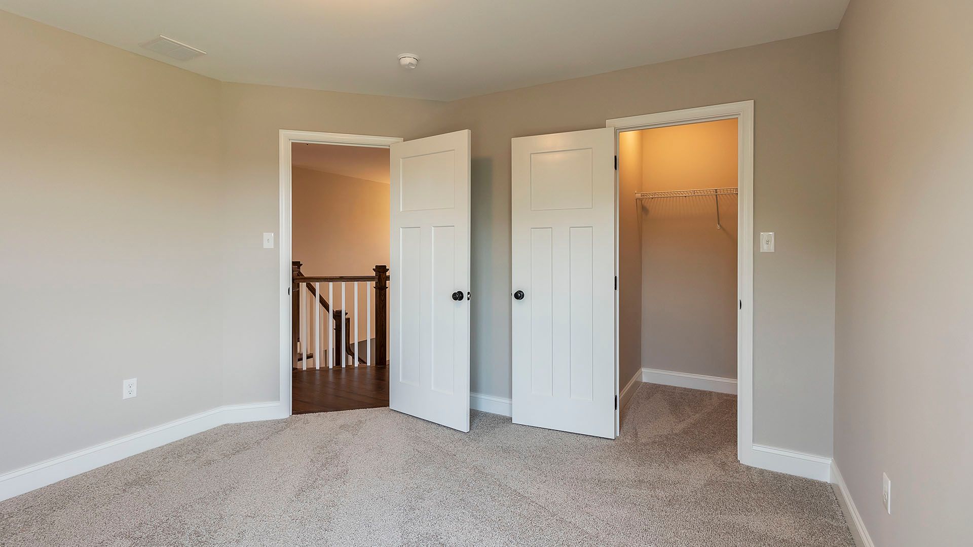 Bedroom 3 with carpet. door leading to hallway, door leading to closet
