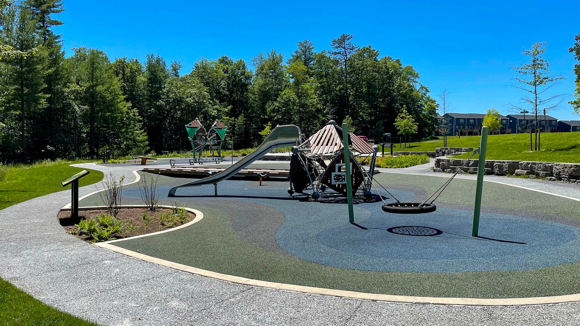 Grays Woods park - play equipment with Grays Pointe townhomes in background