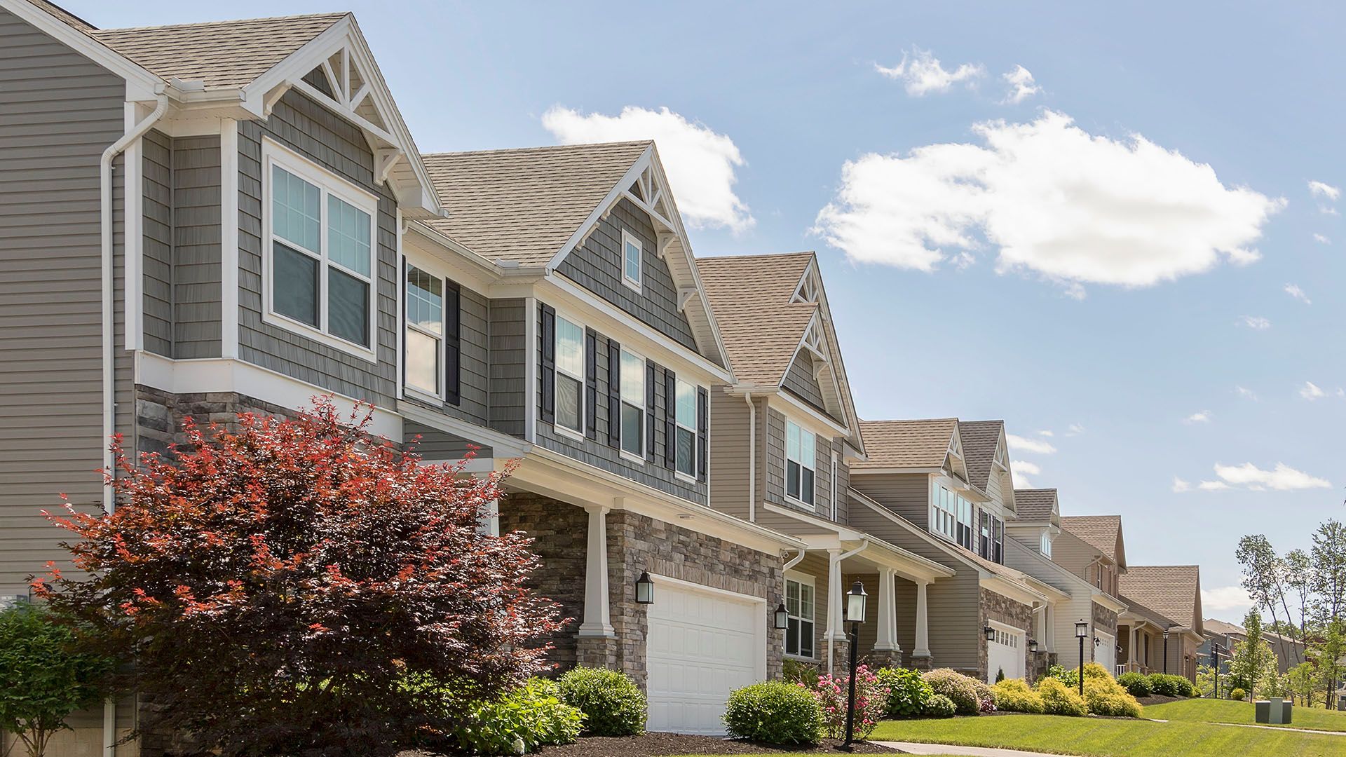 New homes at Honors Crossing II in State College by S&A Homes - Streetscape photo - two story homes with Craftsman style exteriors and 2 car garage