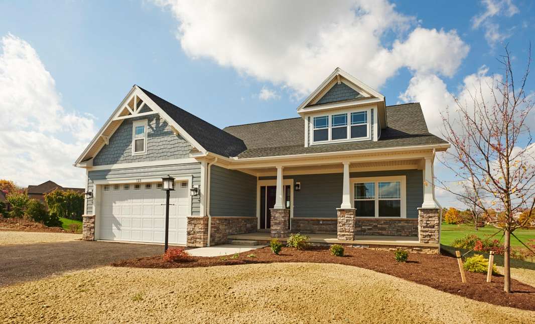Chatham floorplan in Village at Canterbury community by S&A homes in State College - ranch style home with covered porch, partial stone front, dormer, and 2 car garage