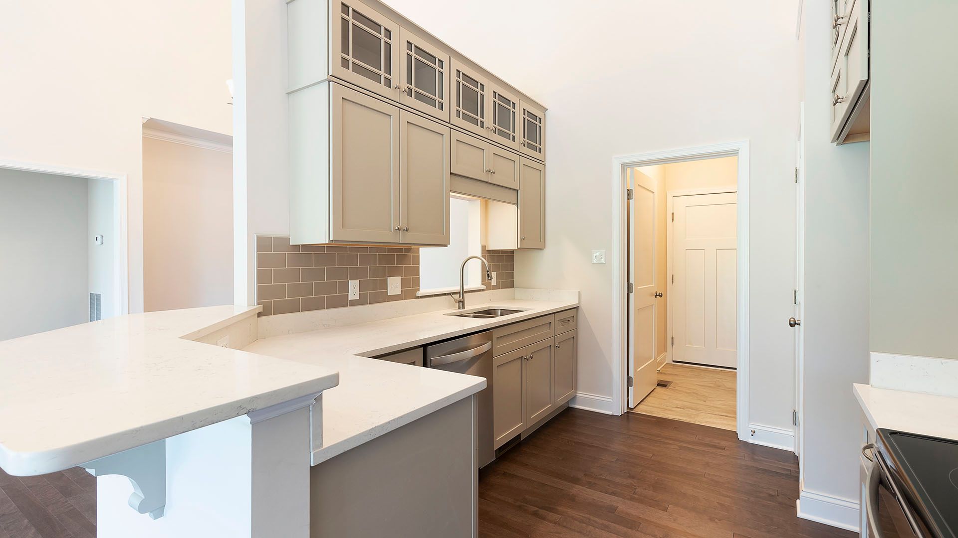 Kitchen with glass door cabinets, look through to dining room, and hardwood flooring, Chilton plan