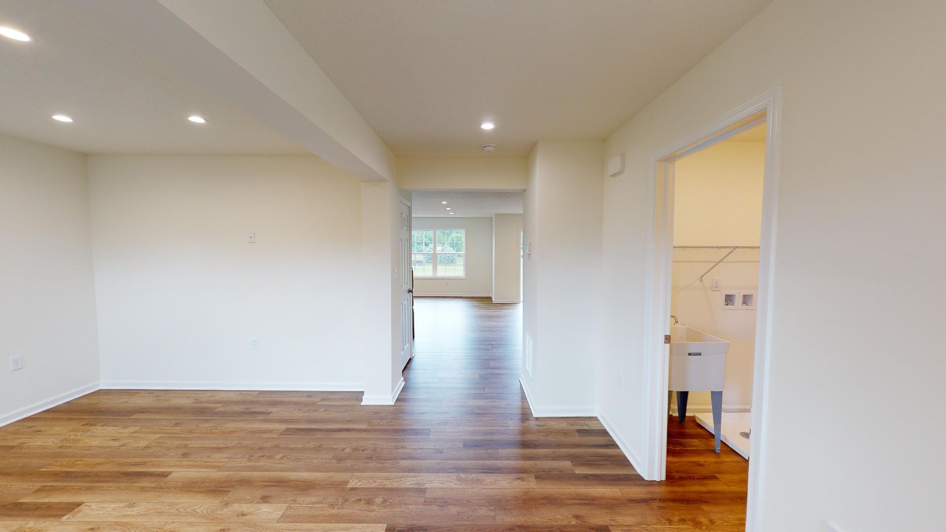 Foyer entry - living room on left, mudroom on right - vinyl plank flooring