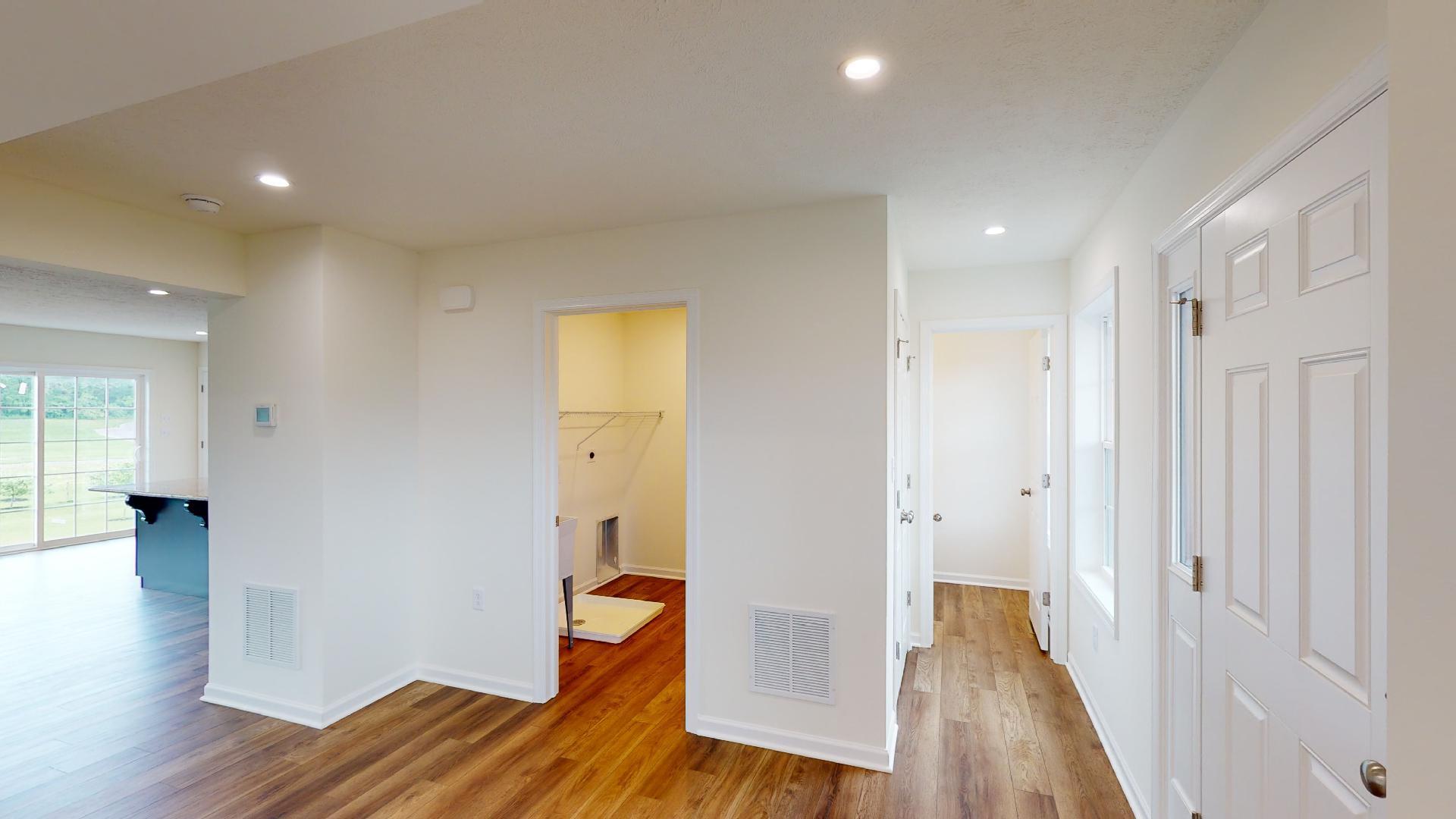 Facing entrances to powder room, laundry and kitchen area
