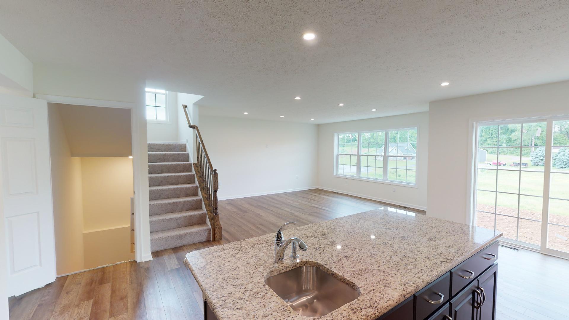 Kitchen island with bar sink - facing staircase and family room area