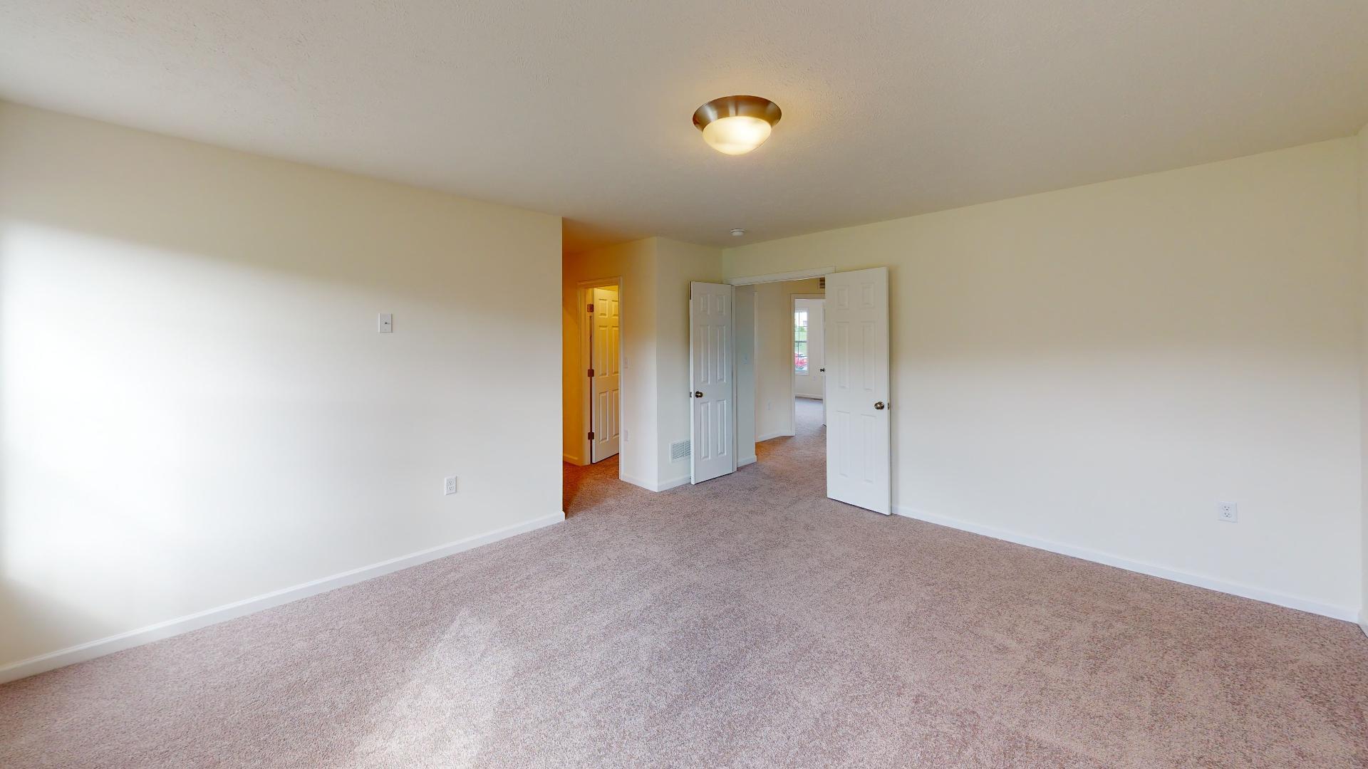 Owner's bedroom - facing entrances to bathroom area and hallway