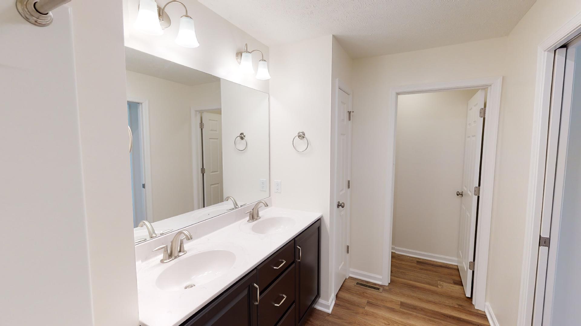 Owner's bath - double bowl vanity with mirror above - facing water closet