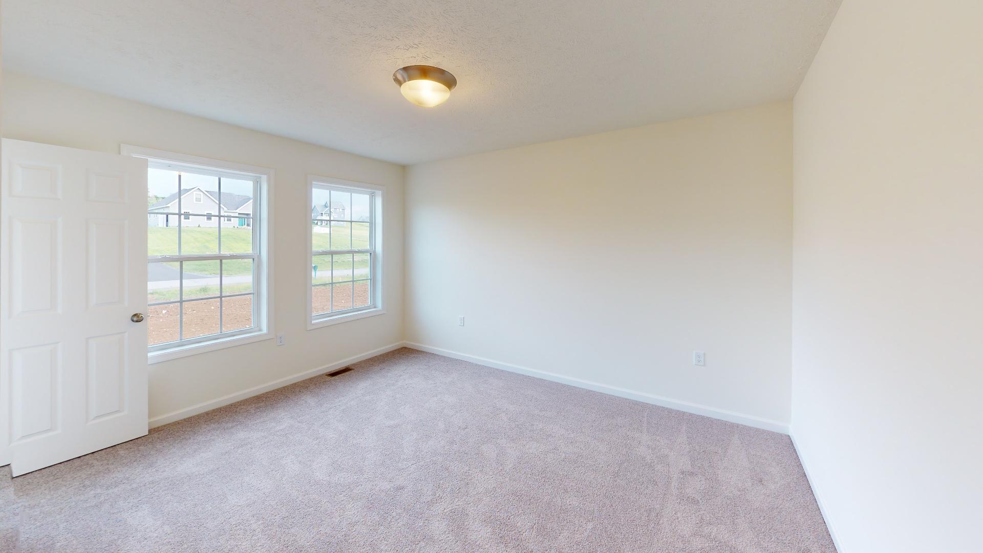 Bedroom 2 - double windows on front wall and carpet flooring