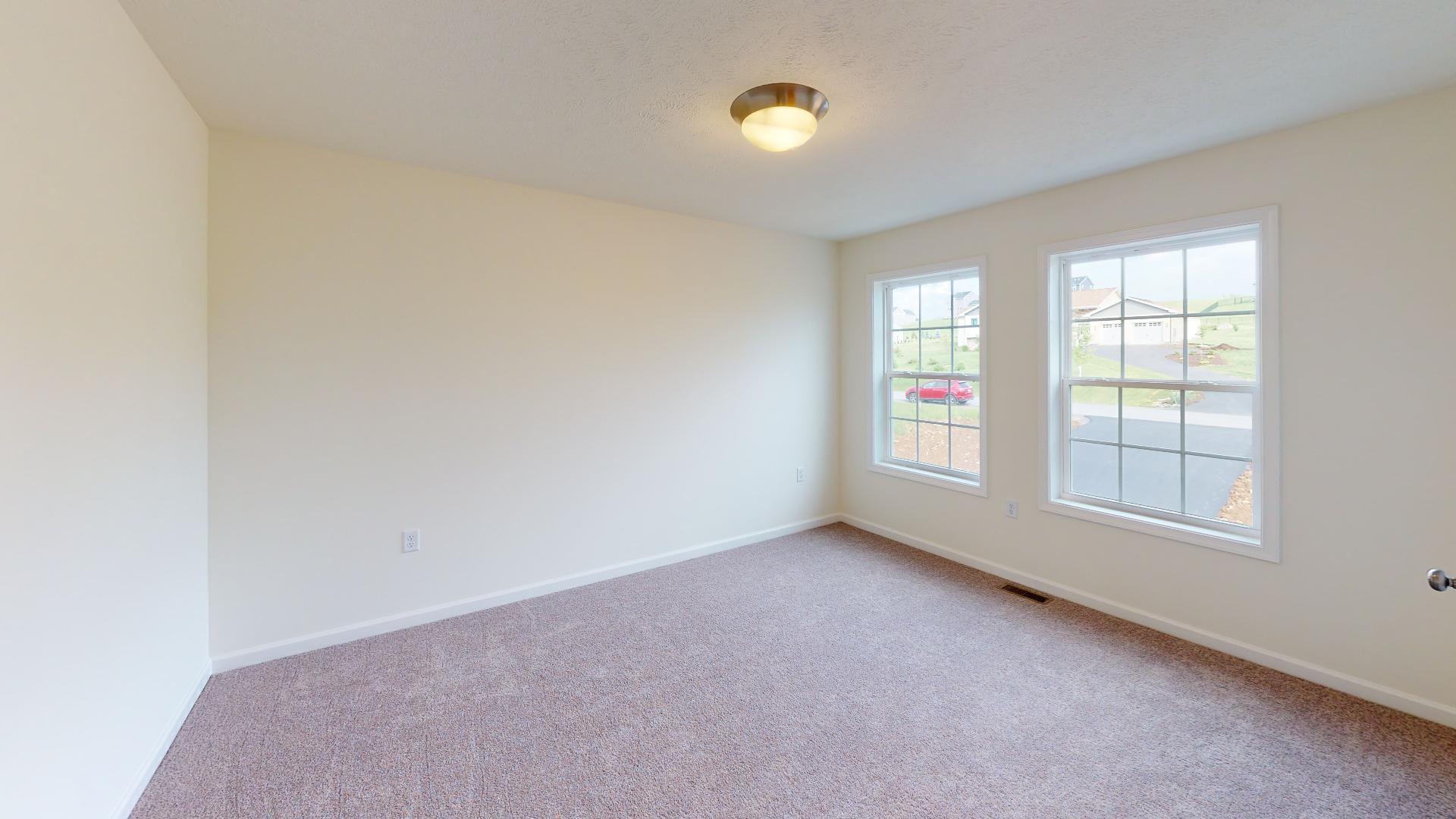 Bedroom 2 - double windows on front wall and carpet flooring