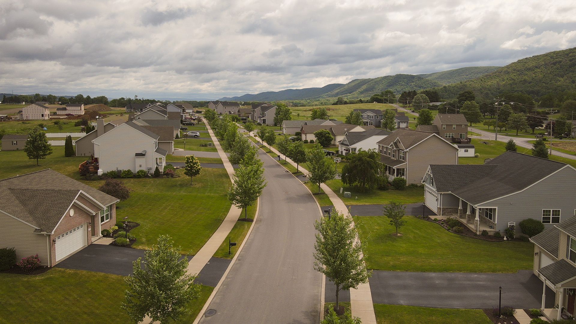 Aerial view of a single family home neighborhood with mountains in the distance