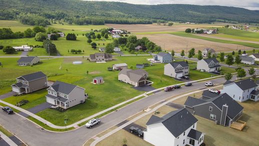 Aerial view of a single family home neighborhood with mountains in the distance