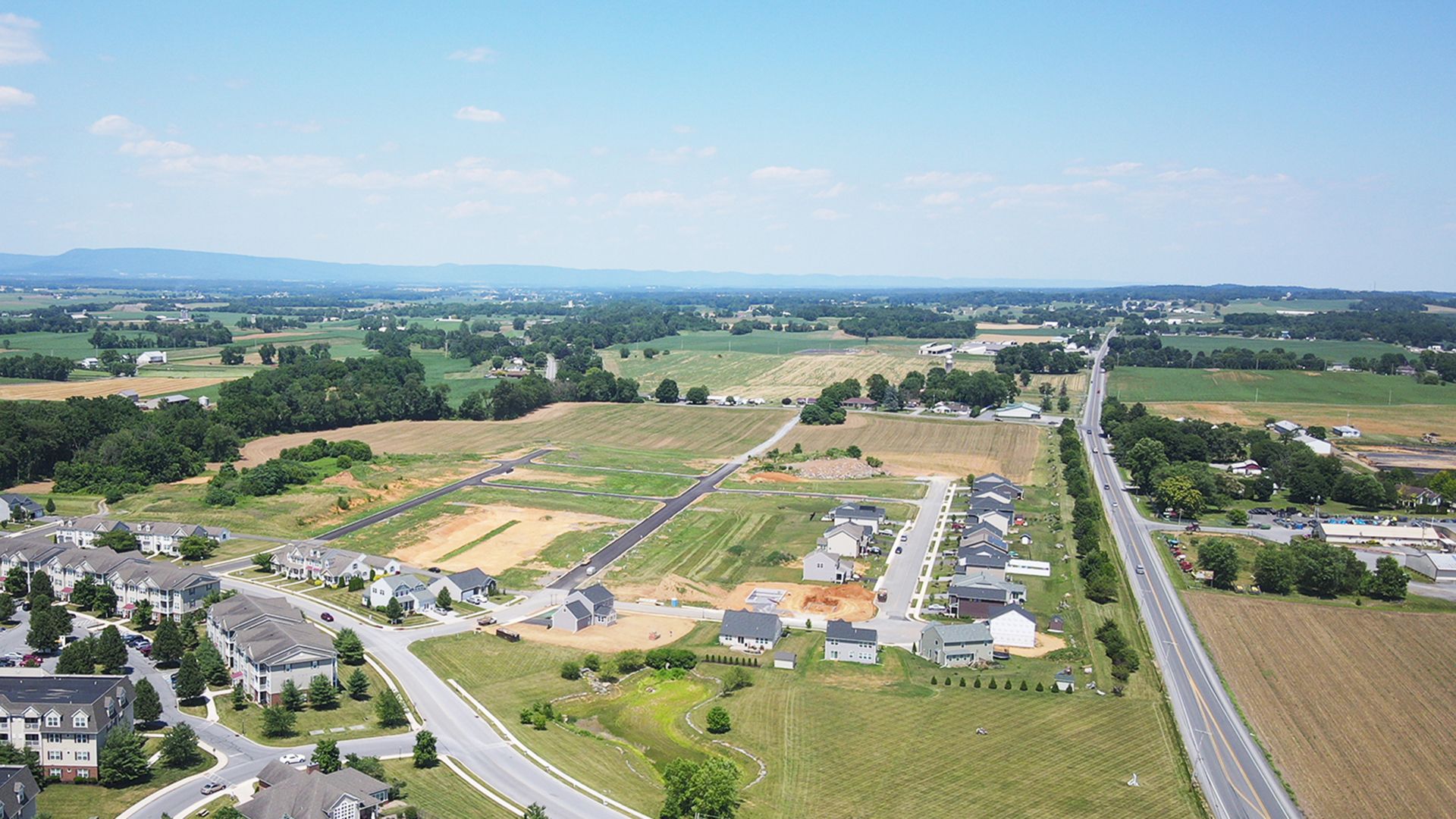 Deerfield single family homes community - surrounded by trees and mountains in the distance