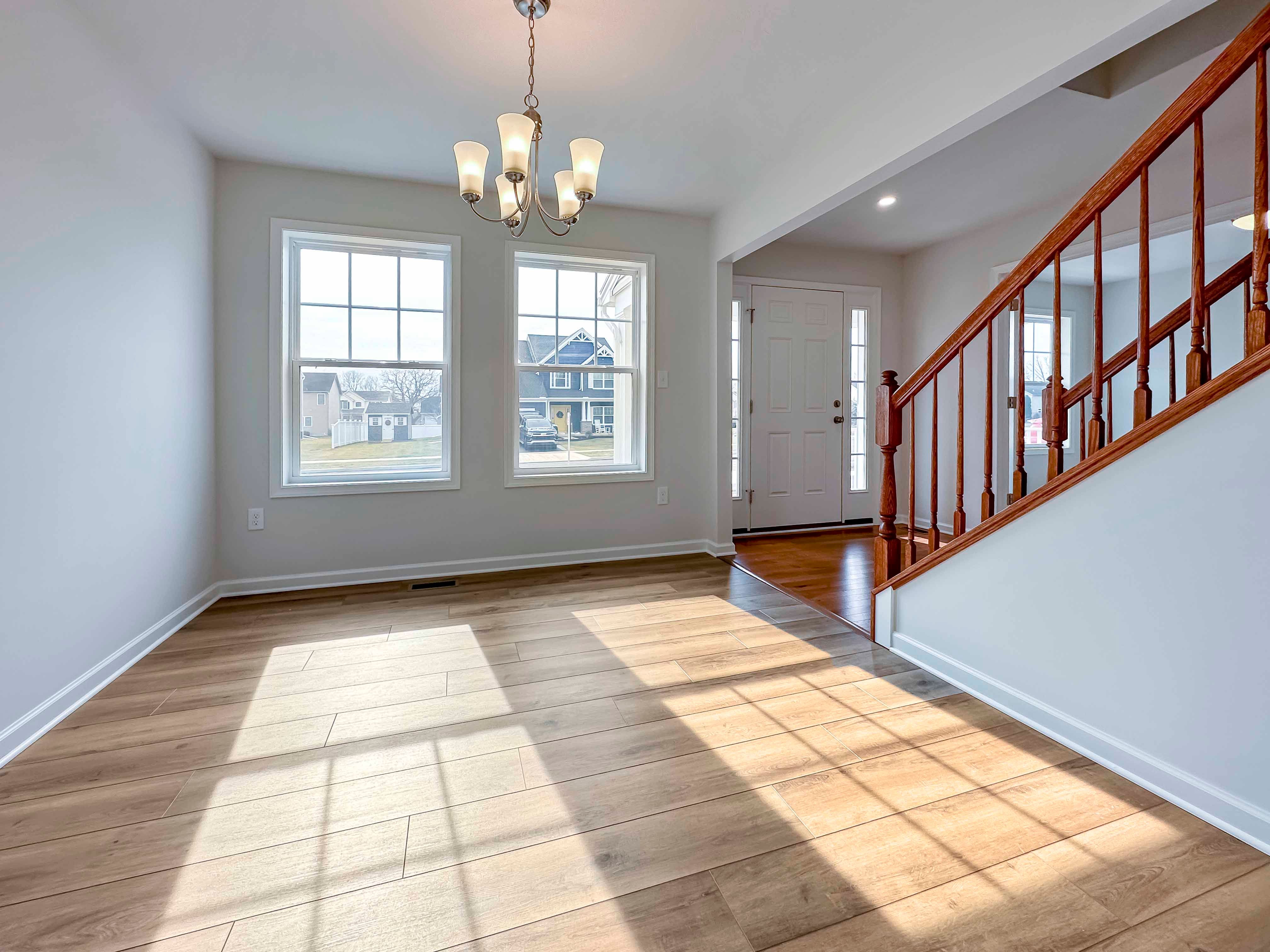 Dining room with hanging fixture - two windows on the front wall