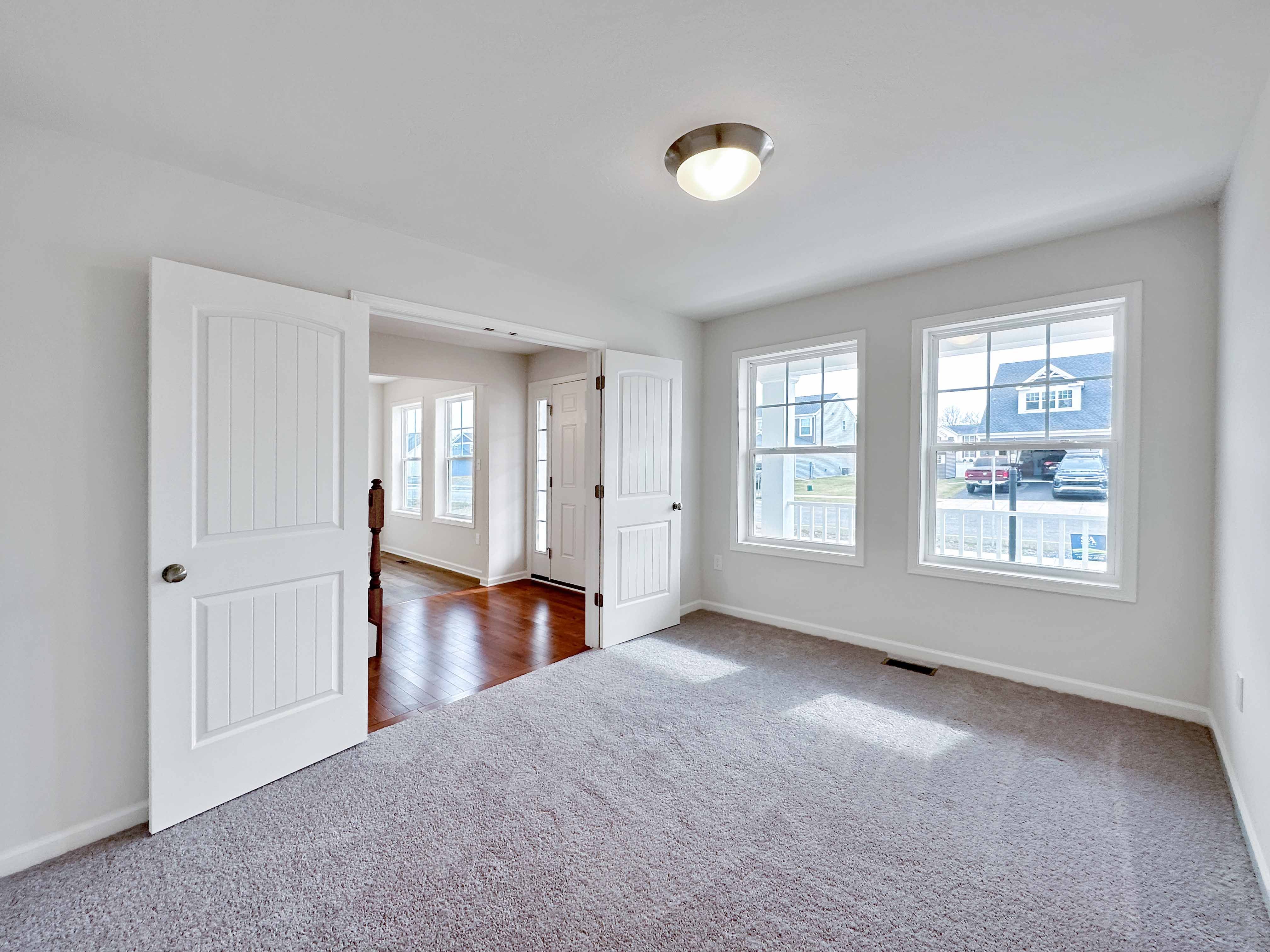 Study with double door entry and two windows on front wall