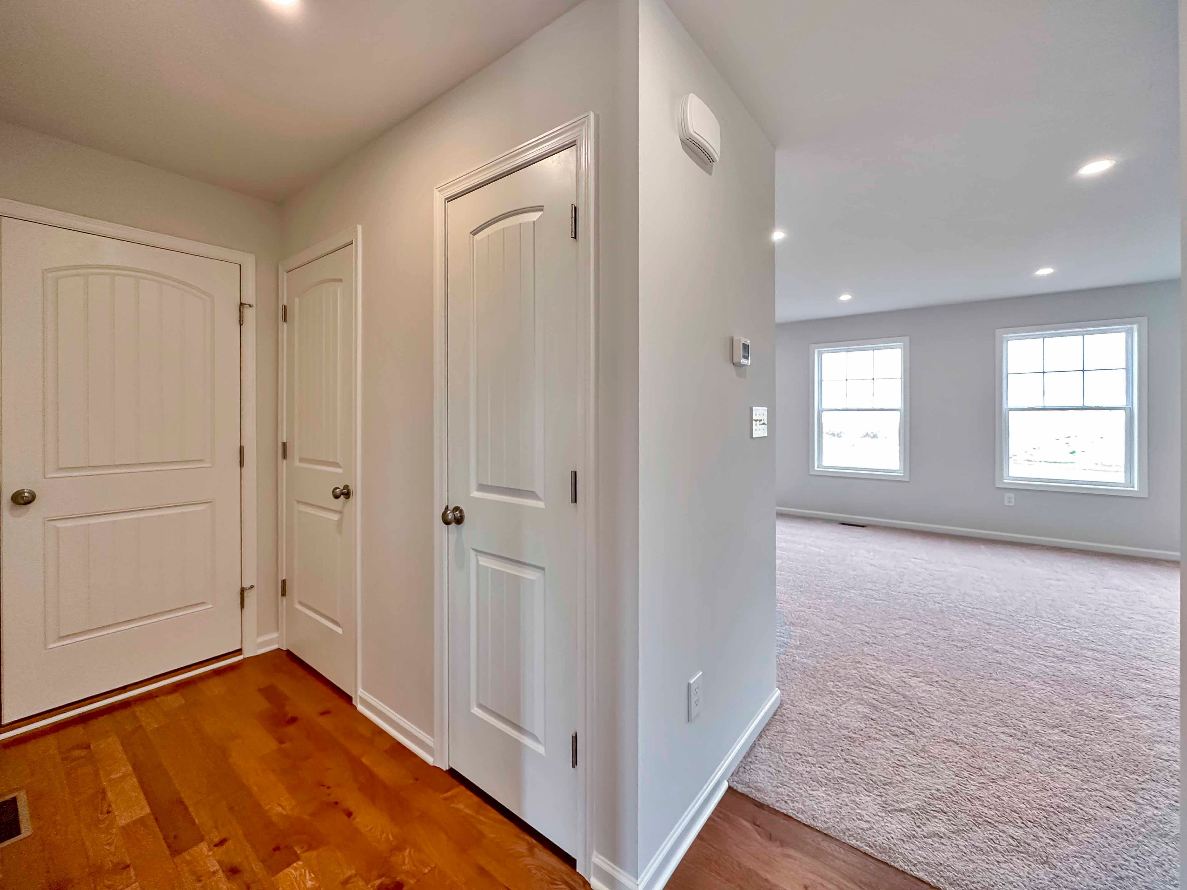 Hallway to garage, powder room and closet